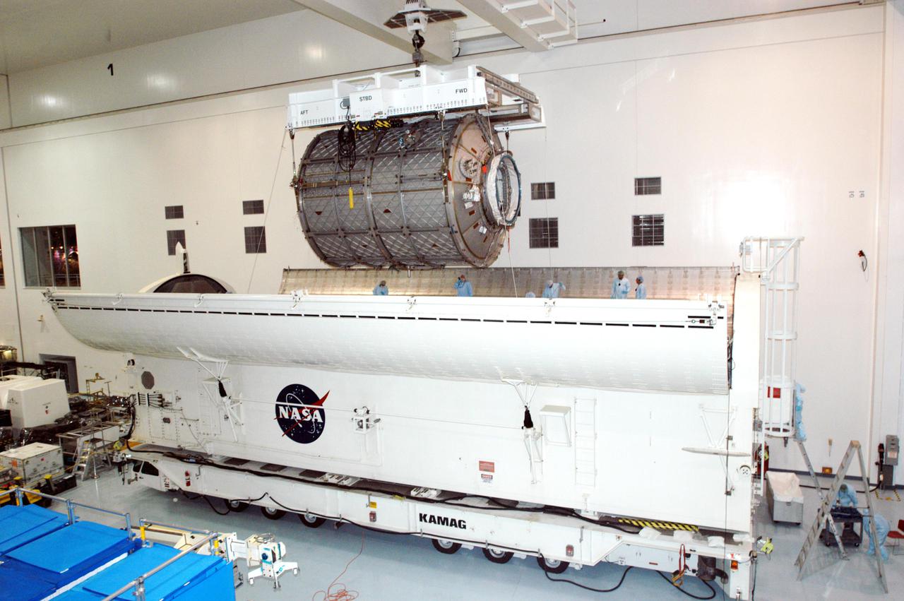 KENNEDY SPACE CENTER, FLA. -  The Multi-Purpose Logistics Module Leonardo is lifted from the payload canister in the Space Station Processing Facility.  The MPLM will be placed in the Cargo Element Work Stand that Raffaello recently vacated.  The payload canister was a temporary location during the switch.  Three MPLMs were built by the Italian Space Agency - Donatello, Leonardo and Raffaello - to serve as a reusable logistics carrier and primary delivery system to resupply and return cargo requiring a pressurized environment to the International Space Station.