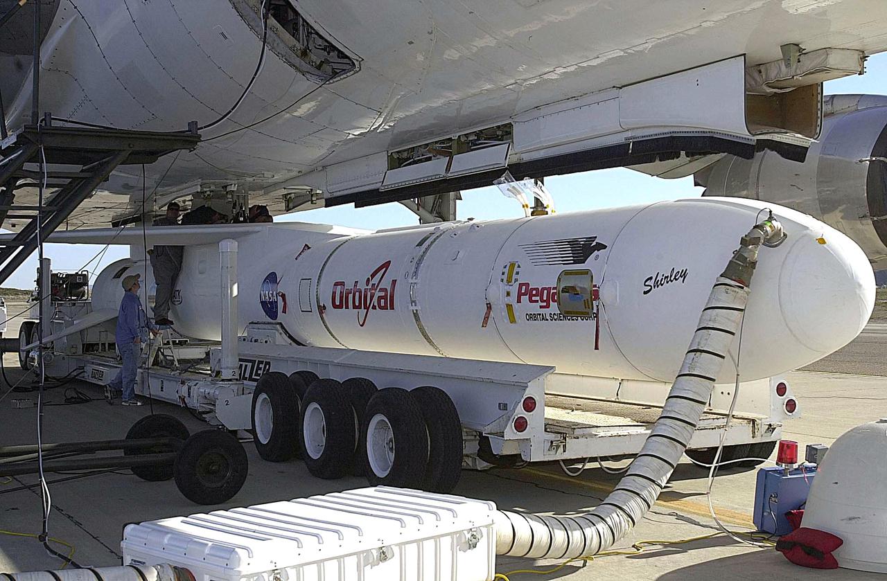 KENNEDY SPACE CENTER, FLA. - At Vandenberg Air Force Base in California, the Orbital Sciences Pegasus XL launch vehicle and Demonstration of Autonomous Rendezvous Technology (DART) spacecraft, which are mated, are being attached to the underbelly of the Orbital Sciences L-1011 aircraft for launch Nov. 9. DART was designed and built for NASA by Orbital Sciences as an advanced flight demonstrator to locate and maneuver near an orbiting satellite. The DART spacecraft weighs about 800 pounds and is nearly 6 feet long and 3 feet in diameter. The Pegasus XL vehicle will launch DART into a circular polar orbit of approximately 475 miles. Once in orbit, DART will make contact with a target satellite, the Multiple Paths, Beyond-Line-of-Sight Communications (MUBLCOM), also built by Orbital Sciences and launched in 1999. DART will then perform several close-proximity operations, such as moving toward and away from the satellite using navigation data provided by on-board sensors. The entire mission will last only 24 hours and will be accomplished without human intervention. The DART flight computer will determine its own path to accomplish its mission objectives.