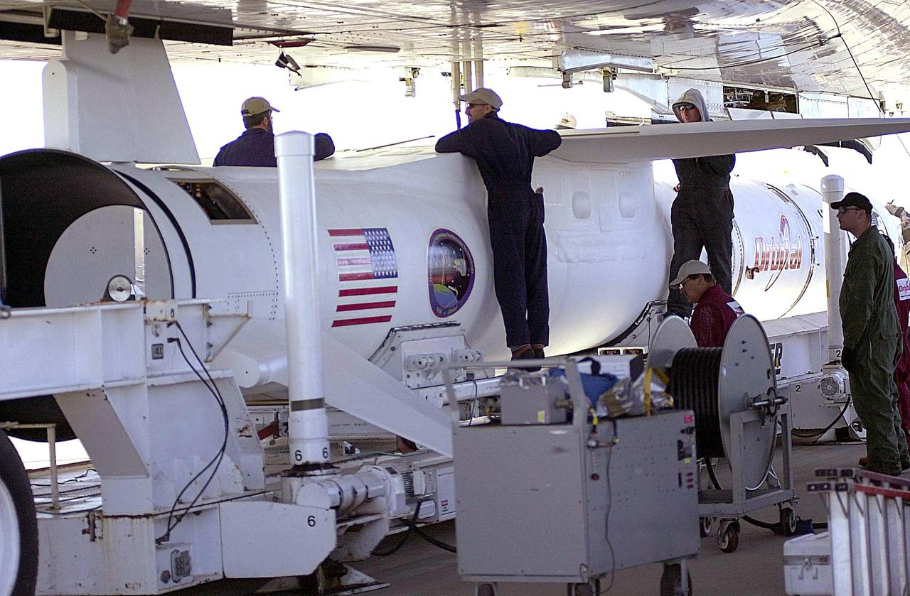 KENNEDY SPACE CENTER, FLA. - At Vandenberg Air Force Base in California, the Orbital Sciences Pegasus XL launch vehicle and Demonstration of Autonomous Rendezvous Technology (DART) spacecraft, which are mated, are being attached to the underbelly of the Orbital Sciences L-1011 aircraft for launch Nov. 9. DART was designed and built for NASA by Orbital Sciences as an advanced flight demonstrator to locate and maneuver near an orbiting satellite. The DART spacecraft weighs about 800 pounds and is nearly 6 feet long and 3 feet in diameter. The Pegasus XL vehicle will launch DART into a circular polar orbit of approximately 475 miles. Once in orbit, DART will make contact with a target satellite, the Multiple Paths, Beyond-Line-of-Sight Communications (MUBLCOM), also built by Orbital Sciences and launched in 1999. DART will then perform several close-proximity operations, such as moving toward and away from the satellite using navigation data provided by on-board sensors. The entire mission will last only 24 hours and will be accomplished without human intervention. The DART flight computer will determine its own path to accomplish its mission objectives.