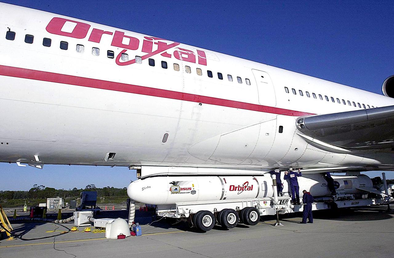 KENNEDY SPACE CENTER, FLA. - Workers at Vandenberg Air Force Base in California finish attaching the Orbital Sciences Pegasus XL launch vehicle and Demonstration of Autonomous Rendezvous Technology (DART) spacecraft to the underbelly of the Orbital Sciences L-1011 aircraft for launch Nov. 9. DART was designed and built for NASA by Orbital Sciences as an advanced flight demonstrator to locate and maneuver near an orbiting satellite. The DART spacecraft weighs about 800 pounds and is nearly 6 feet long and 3 feet in diameter. The Pegasus XL vehicle will launch DART into a circular polar orbit of approximately 475 miles. Once in orbit, DART will make contact with a target satellite, the Multiple Paths, Beyond-Line-of-Sight Communications (MUBLCOM), also built by Orbital Sciences and launched in 1999. DART will then perform several close-proximity operations, such as moving toward and away from the satellite using navigation data provided by on-board sensors. The entire mission will last only 24 hours and will be accomplished without human intervention. The DART flight computer will determine its own path to accomplish its mission objectives.