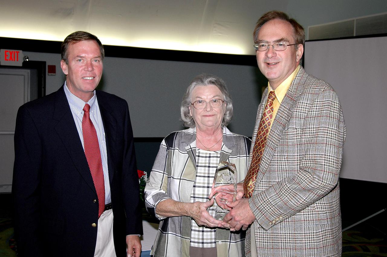 KENNEDY SPACE CENTER, FLA. - NASA public affairs specialist George Diller (right) is honored with a Harry Kolcum Memorial News and Communications Award for 2004 by the National Space Club Florida Committee at the Radisson Resort at the Port, Cape Canaveral, Fla. He is joined by Committee Chairman Jerry Moyer (left) and Eddie Kolcum, wife of the late journalist for whom the award is named. Each year, the National Space Club Florida Committee recognizes area representatives of the news media and communications professions for excellence in their ability to communicate the space story along Florida’s Space Coast and throughout the world. The award is named in honor of Harry Kolcum, the former managing editor of Aviation Week and Space Technology, who was Cape bureau chief from 1980 to 1993 prior to his death in 1994. Kolcum was a founding member of the National Space Club Florida Committee.