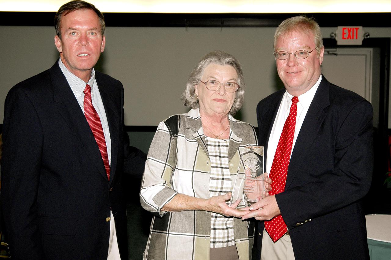 KENNEDY SPACE CENTER, FLA. - Florida Today senior aerospace reporter Todd Halvorson (right) is honored with a Harry Kolcum Memorial News and Communications Award for 2004 by the National Space Club Florida Committee at the Radisson Resort at the Port, Cape Canaveral, Fla. He is joined by Committee Chairman Jerry Moyer (left) and Eddie Kolcum, wife of the late journalist for whom the award is named. Each year, the National Space Club Florida Committee recognizes area representatives of the news media and communications professions for excellence in their ability to communicate the space story along Florida’s Space Coast and throughout the world. The award is named in honor of Harry Kolcum, the former managing editor of Aviation Week and Space Technology, who was Cape bureau chief from 1980 to 1993 prior to his death in 1994. Kolcum was a founding member of the National Space Club Florida Committee.