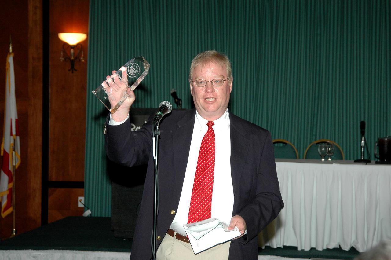 KENNEDY SPACE CENTER, FLA. - Florida Today senior aerospace reporter Todd Halvorson is honored with a Harry Kolcum Memorial News and Communications Award for 2004 by the National Space Club Florida Committee at the Radisson Resort at the Port, Cape Canaveral, Fla. Each year, the National Space Club Florida Committee recognizes area representatives of the news media and communications professions for excellence in their ability to communicate the space story along Florida’s Space Coast and throughout the world. The award is named in honor of Harry Kolcum, the former managing editor of Aviation Week and Space Technology, who was Cape bureau chief from 1980 to 1993 prior to his death in 1994. Kolcum was a founding member of the National Space Club Florida Committee.