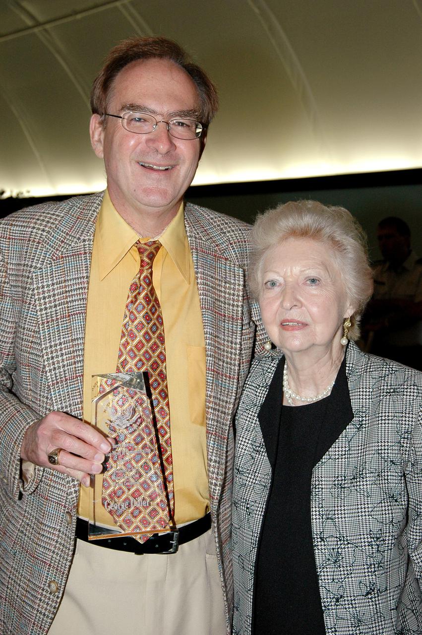 KENNEDY SPACE CENTER, FLA. - NASA public affairs specialist George Diller (left) is honored with a Harry Kolcum Memorial News and Communications Award for 2004 by the National Space Club Florida Committee at the Radisson Resort at the Port, Cape Canaveral, Fla. He is joined by Marcie Young, wife of the late chief of NASA news operations at Kennedy Space Center, Dick Young, with whom Diller worked for many years. Each year, the National Space Club Florida Committee recognizes area representatives of the news media and communications professions for excellence in their ability to communicate the space story along Florida’s Space Coast and throughout the world. The award is named in honor of Harry Kolcum, the former managing editor of Aviation Week and Space Technology, who was Cape bureau chief from 1980 to 1993 prior to his death in 1994. Kolcum was a founding member of the National Space Club Florida Committee.