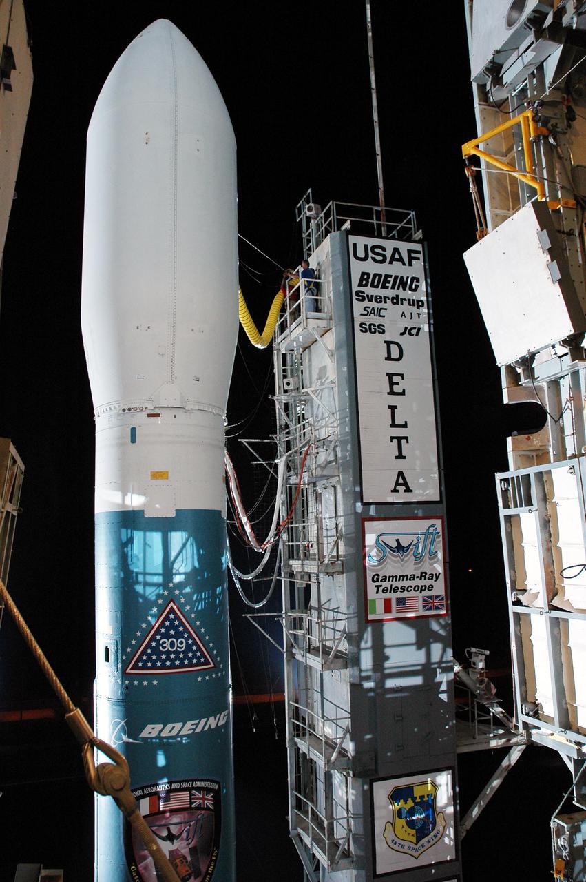 KENNEDY SPACE CENTER, FLA. -   A Boeing Delta II expendable launch vehicle stands ready to launch NASA’s Swift spacecraft following tower rollback at Complex 17A, Cape Canaveral Air Force Station.  Swift is a first-of-its-kind multi-wavelength observatory dedicated to the study of gamma-ray burst science. Its three instruments will work together to observe GRBs and afterglows in the gamma ray, X-ray, ultraviolet and optical wavebands. Swift is scheduled to launch Nov. 20 at 12:10 p.m. EST.