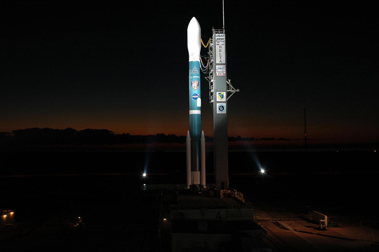 KENNEDY SPACE CENTER, FLA. -   A Boeing Delta II expendable launch vehicle stands ready to launch NASA’s Swift spacecraft following tower rollback at Complex 17A, Cape Canaveral Air Force Station.  Swift is a first-of-its-kind multi-wavelength observatory dedicated to the study of gamma-ray burst science. Its three instruments will work together to observe GRBs and afterglows in the gamma ray, X-ray, ultraviolet and optical wavebands. Swift is scheduled to launch Nov. 20 at 12:10 p.m. EST.