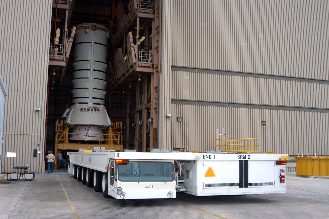 KENNEDY SPACE CENTER, FLA. -   The transporter arrives at the Rotation Processing and Surge Facility to move the aft skirt and lower segment of the Solid Rocket Booster (SRB) to the Vehicle Assembly.  These segments are the first to be prepared for Return to Flight on mission STS-114.  Other segments will follow for stacking.  Two SRBs support the liftoff of the Space Shuttle on a launch.  The twin 149-foot tall, 12-foot diameter SRBs provide the main propulsion system during launch to place the 180,000-pound orbiters in the proper orbit around the Earth.  They operate parallel with the Space Shuttle main engines for the first two minutes of flight and jettison away from the orbiter with help from the Booster Separation Motors, about 26.3 nautical miles above the Earth’s surface.