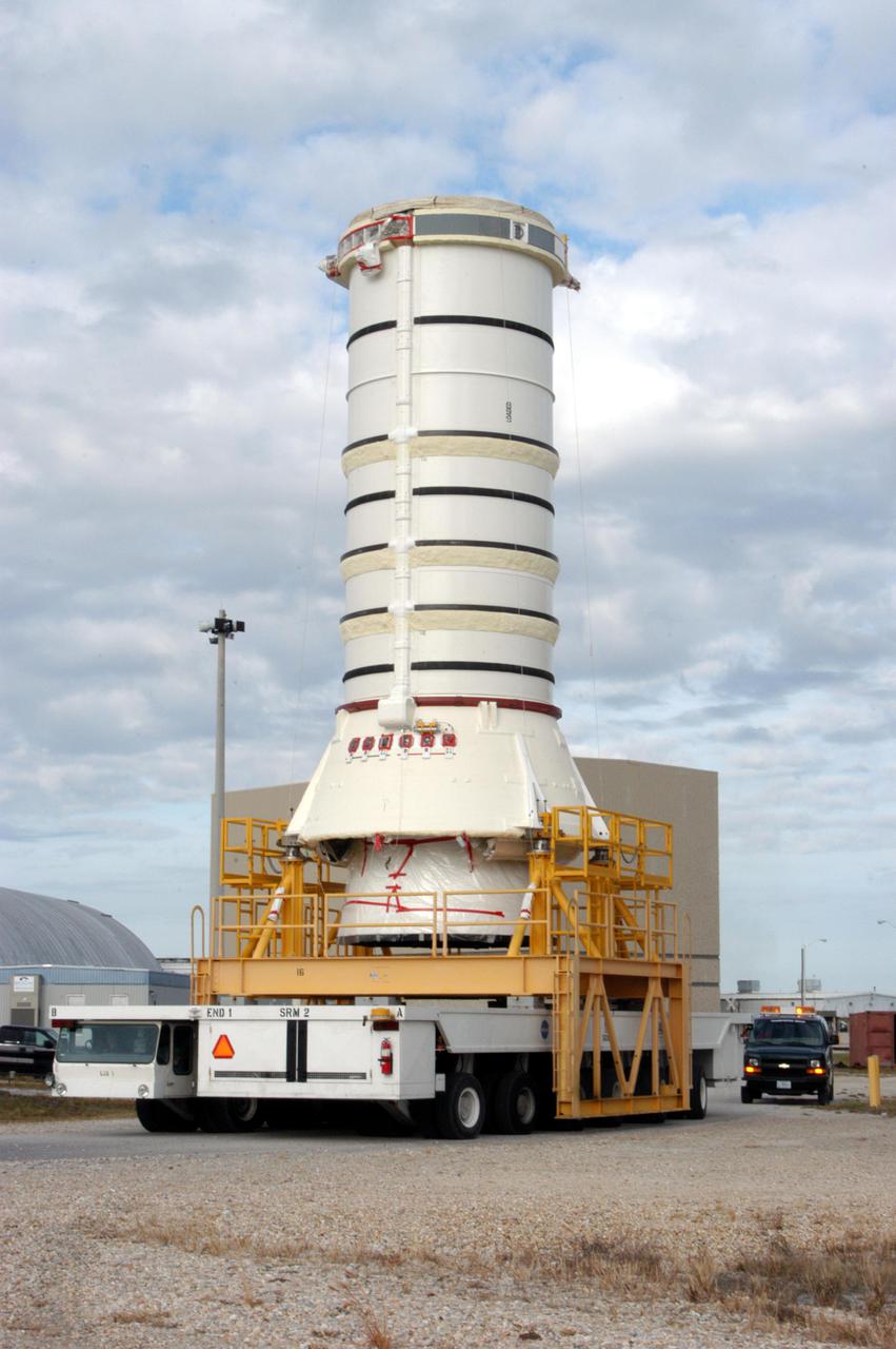 KENNEDY SPACE CENTER, FLA. -   -  The aft skirt and lower segment of the Solid Rocket Booster (SRB) being prepared for Return to Flight on mission STS-114 are being transported from the Rotation Processing and Surge Facility to the Vehicle Assembly Building.  Other segments will be moved to the VAB later for stacking.  Two SRBs support the liftoff of the Space Shuttle on a launch.  The twin 149-foot tall, 12-foot diameter SRBs provide the main propulsion system during launch to place the 180,000-pound orbiters in the proper orbit around the Earth.  They operate parallel with the Space Shuttle main engines for the first two minutes of flight and jettison away from the orbiter with help from the Booster Separation Motors, about 26.3 nautical miles above the Earth’s surface.