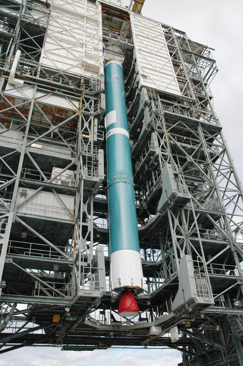 KENNEDY SPACE CENTER, FLA. -   On Launch Pad 17-B on Cape Canaveral Air Force Station, Fla., the first stage of the Boeing Delta II launch vehicle for the Deep Impact spacecraft is lifted into the mobile service tower for stacking with the other stages.  A NASA Discovery mission, Deep Impact will probe beneath the surface of Comet Tempel 1 on July 4, 2005, when the comet is 83 million miles from Earth, and reveal the secrets of its interior. After releasing a 3- by 3-foot projectile to crash onto the surface, Deep Impact’s flyby spacecraft will collect pictures and data of how the crater forms, measuring the crater’s depth and diameter, as well as the composition of the interior of the crater and any material thrown out, and determining the changes in natural outgassing produced by the impact.  It will send the data back to Earth through the antennas of the Deep Space Network.  Deep Impact project management is handled by the Jet Propulsion Laboratory in Pasadena, Calif.  The spacecraft is scheduled to launch Dec. 30, 2004.