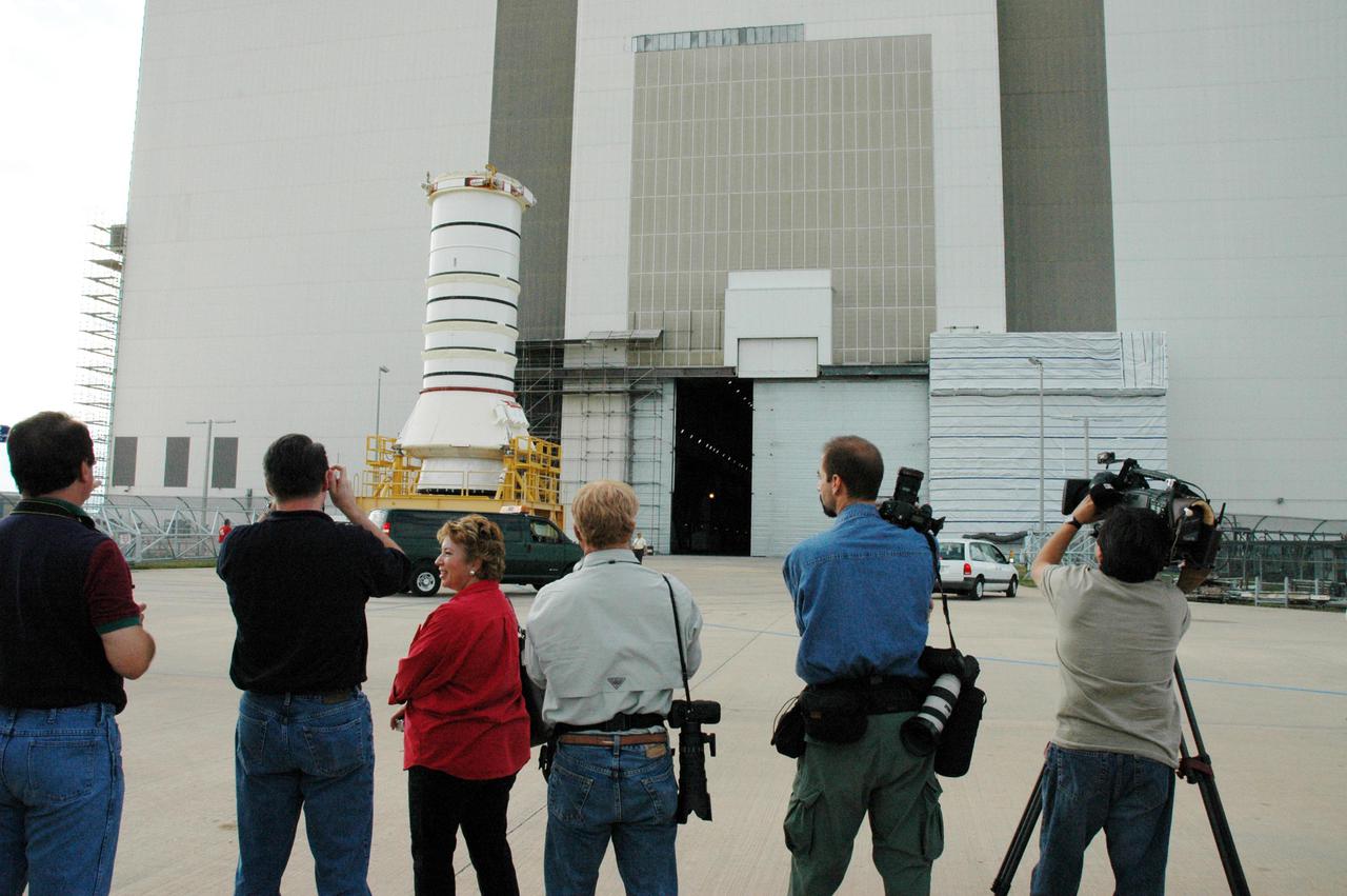 KENNEDY SPACE CENTER, FLA. -   Photographers shoot the movement of the aft skirt and lower segment of the Solid Rocket Booster for the Return to Flight mission STS-114 as it nears the Vehicle Assembly Building.  This is a significant milestone in Return to Flight preparations.  Other segments will follow for stacking.  Two SRBs support the liftoff of the Space Shuttle on a launch.  The twin 149-foot tall, 12-foot diameter SRBs provide the main propulsion system during launch to place the 180,000-pound orbiters in the proper orbit around the Earth.  They operate parallel with the Space Shuttle main engines for the first two minutes of flight and jettison away from the orbiter with help from the Booster Separation Motors, about 26.3 nautical miles above the Earth’s surface.