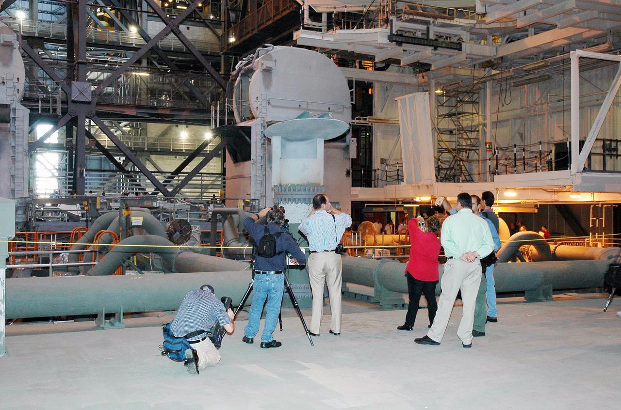 KENNEDY SPACE CENTER, FLA. -   In the Vehicle Assembly Building (VAB), media are shown where the Solid Rocket Booster (SRB) for the Return to Flight mission STS-114 will be stacked on the Mobile Launcher Platform.  The aft skirt and lower segment segment have been transported from the Rotation Processing and Surge Facility to the VAB.  Other segments will follow. Two SRBs support the liftoff of the Space Shuttle on a launch.  The twin 149-foot tall, 12-foot diameter SRBs provide the main propulsion system during launch to place the 180,000-pound orbiters in the proper orbit around the Earth.  They operate parallel with the Space Shuttle main engines for the first two minutes of flight and jettison away from the orbiter with help from the Booster Separation Motors, about 26.3 nautical miles above the Earth’s surface.