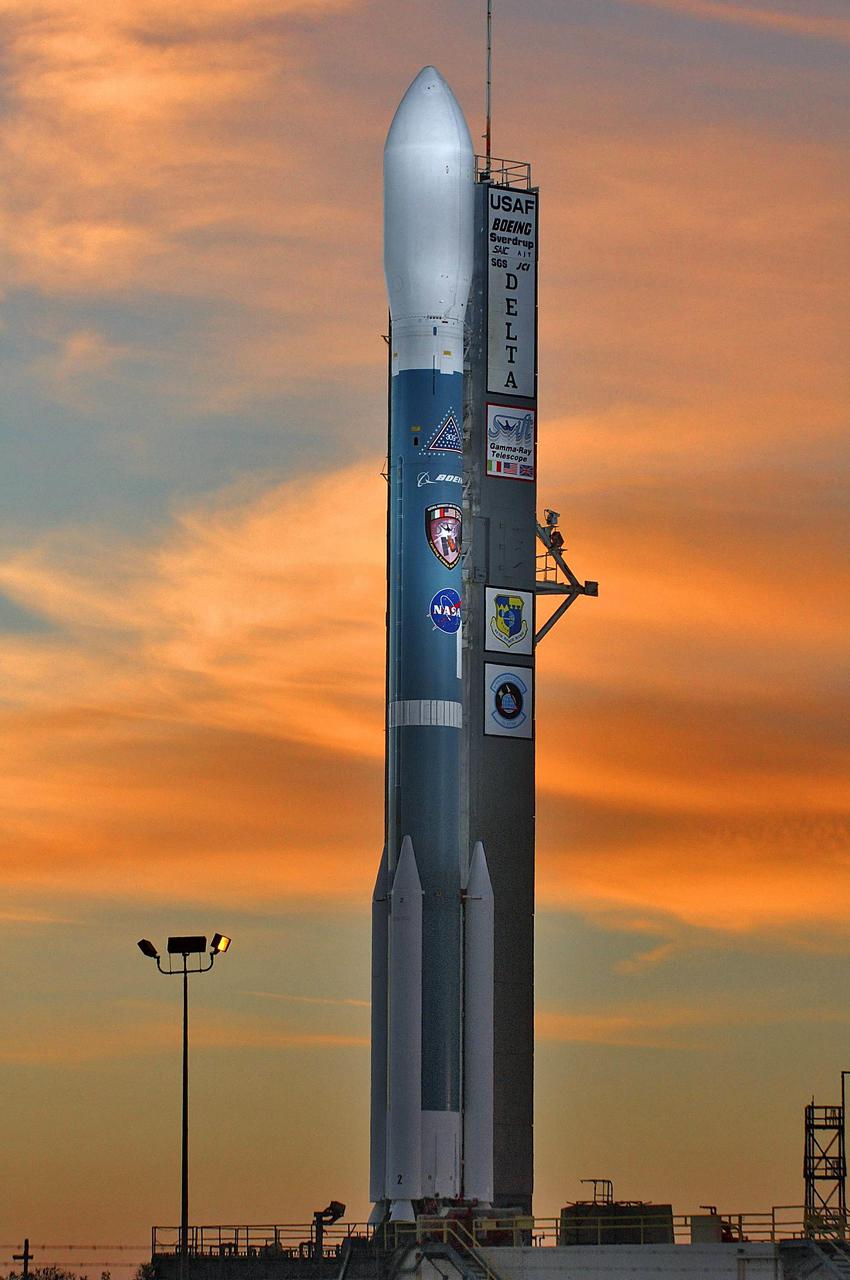 KENNEDY SPACE CENTER, FLA. -   The Boeing Delta II launch vehicle for NASA’s Swift spacecraft is silhouetted against a rosy sky at sunrise, waiting for liftoff scheduled for 12:16:00.611 p.m. EST from Launch Pad 17-A on Cape Canaveral Air Force Station, Fla. Swift is a first-of-its-kind multi-wavelength observatory dedicated to the study of gamma-ray burst science. Its three instruments will work together to observe GRBs and afterglows in the gamma ray, X-ray, ultraviolet and optical wavebands.  [Photo courtesy of Scott Andrews]