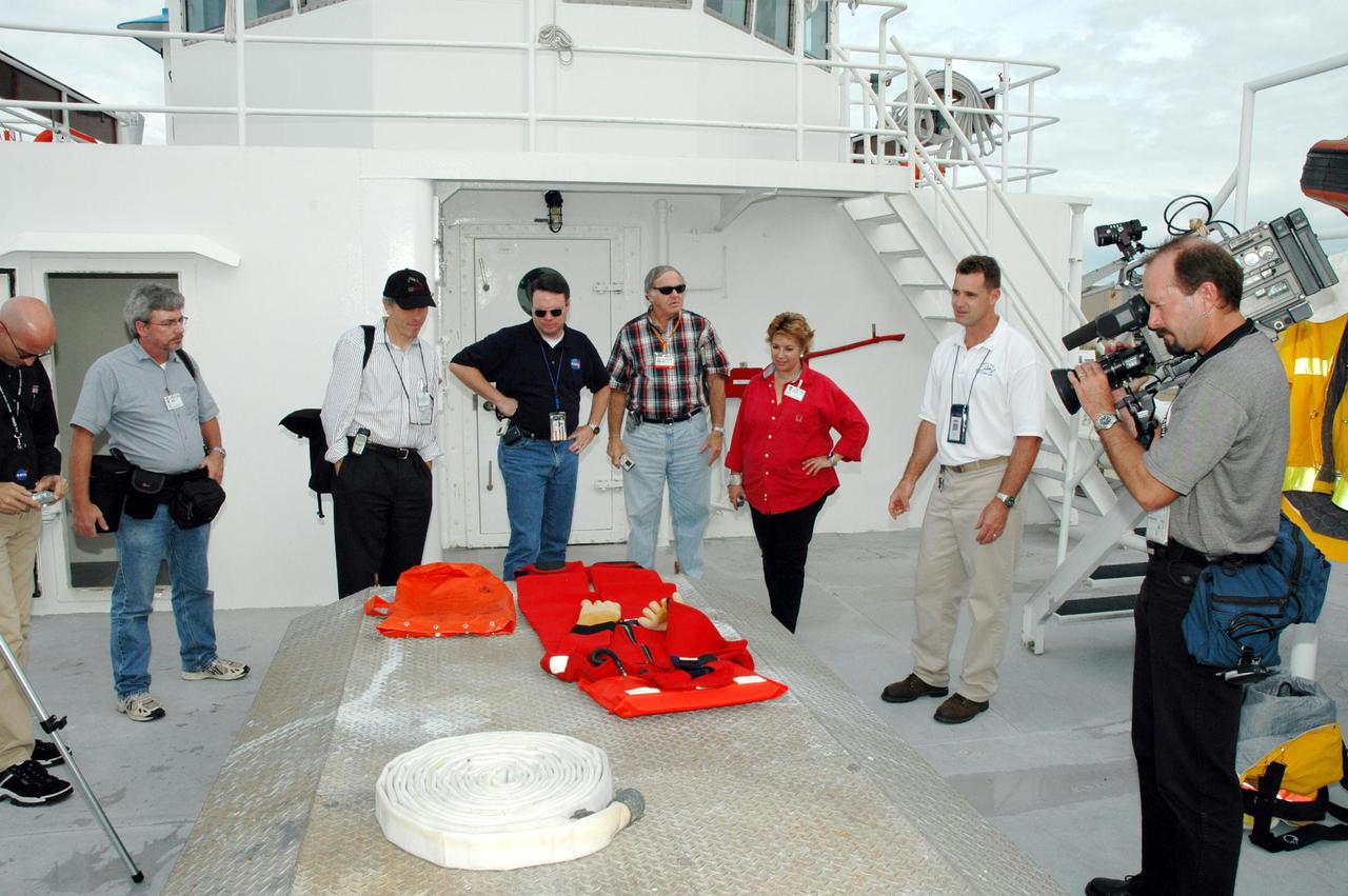 KENNEDY SPACE CENTER, FLA. -  The media look at equipment on board one of the Solid Rocket Booster (SRB) retrieval ships.  The stop was part of a day-long event that featured the movement of the first SRB segments to the Vehicle Assembly Building for stacking for Return to Flight mission STS-114. Two SRBs support the liftoff of the Space Shuttle on a launch.  The twin 149-foot tall, 12-foot diameter SRBs provide the main propulsion system during launch to place the orbiters in the proper orbit around the Earth.  They operate parallel with the Space Shuttle main engines for the first two minutes of flight and jettison away from the orbiter, with help from the Booster Separation Motors, about 26.3 nautical miles above the Earth’s surface.