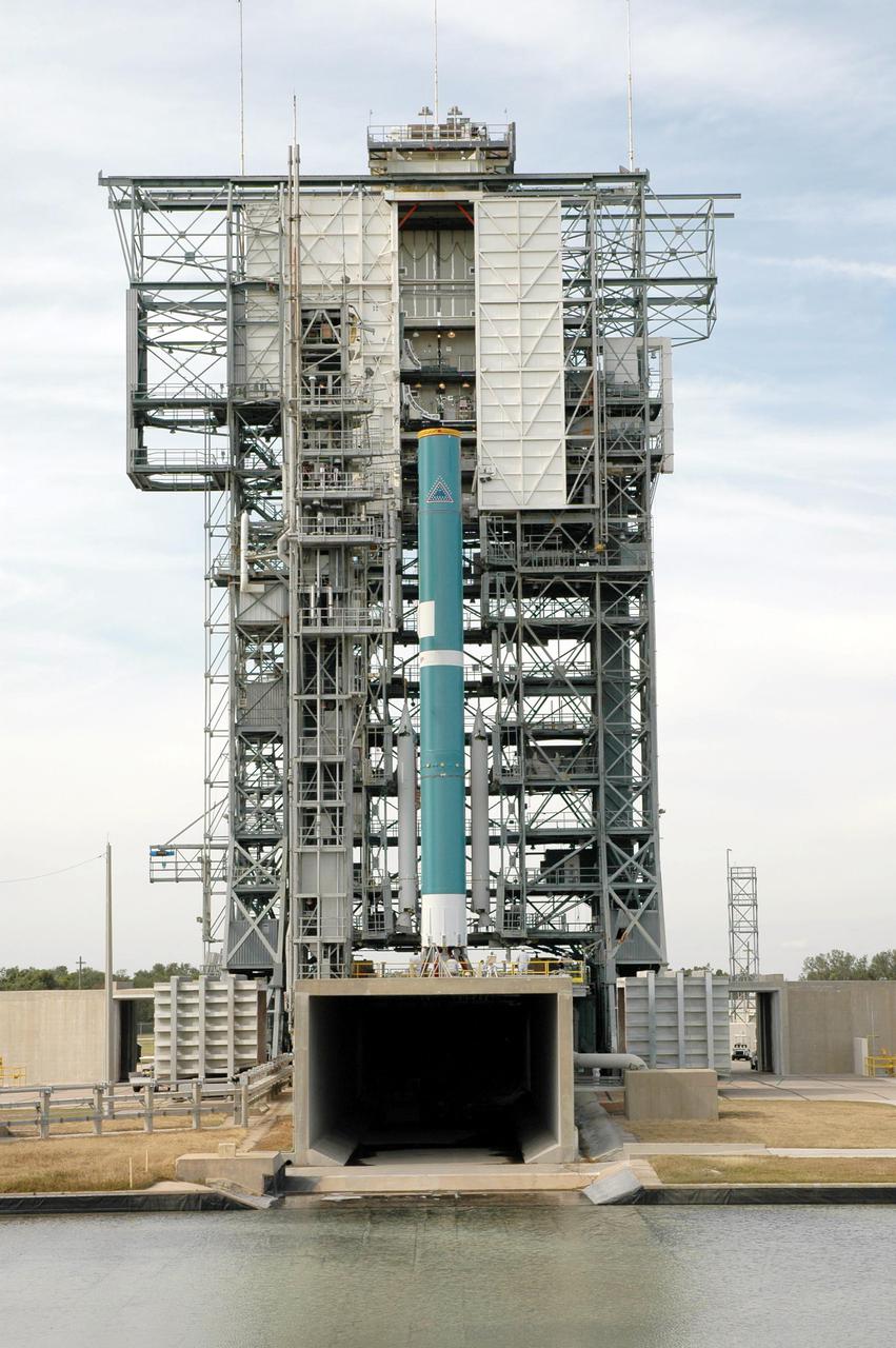 KENNEDY SPACE CENTER, FLA. - On Launch Pad 17-B, Cape Canaveral Air Force Station, Fla., the Boeing Delta II launch vehicle for launch of the Deep Impact spacecraft is seen with three Solid Rocket Boosters (SRBs) attached. A NASA Discovery mission, Deep Impact will probe beneath the surface of Comet Tempel 1 on July 4, 2005, when the comet is 83 million miles from Earth, and reveal the secrets of its interior. After releasing a 3- by 3-foot projectile to crash onto the surface, Deep Impact’s flyby spacecraft will collect pictures and data of how the crater forms, measuring the crater’s depth and diameter, as well as the composition of the interior of the crater and any material thrown out, and determining the changes in natural outgassing produced by the impact. It will send the data back to Earth through the antennas of the Deep Space Network. Deep Impact project management is handled by the Jet Propulsion Laboratory in Pasadena, Calif. The spacecraft is scheduled to launch Dec. 30, 2004.