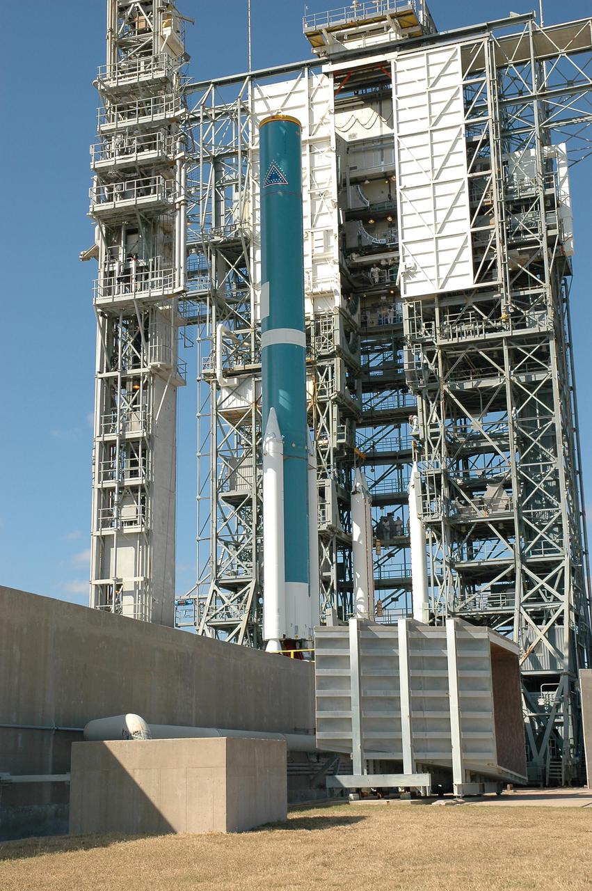 KENNEDY SPACE CENTER, FLA. -  On Launch Pad 17-B, Cape Canaveral Air Force Station, Fla., the mobile service tower with a second set of three Solid Rocket Boosters (SRBs) is moved toward the Boeing Delta II rocket for mating.  A final set of three SRBs is yet to be added. A NASA Discovery mission, Deep Impact will probe beneath the surface of Comet Tempel 1 on July 4, 2005, when the comet is 83 million miles from Earth, and reveal the secrets of its interior.  After releasing an impactor on a course to hit the comet’s sunlit side, Deep Impact’s flyby spacecraft will collect pictures and data of how the crater forms, measure the crater’s depth and diameter, as well as the composition of the interior of the crater and any material thrown out, and determine the changes in natural outgassing produced by the impact.  It will send the data back to Earth through the antennas of the Deep Space Network.