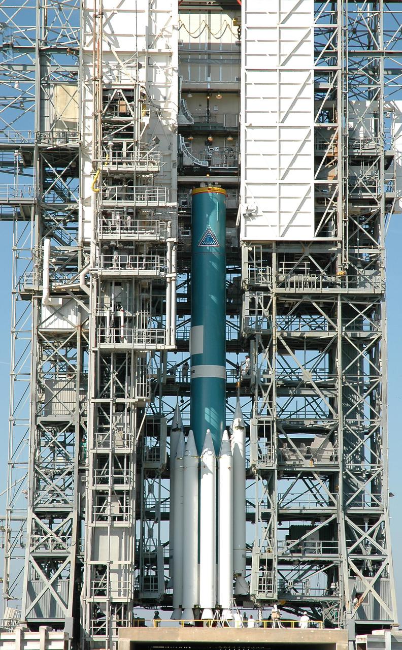 KENNEDY SPACE CENTER, FLA. -  The Boeing Delta II rocket with its complement of nine Solid Rocket Boosters stands complete alongside the gantry.  The Delta II will launch the Deep Impact spacecraft, scheduled for no earlier than Jan. 8, 2005.  Below the rocket is the flame trench, and in the foreground is the overflow pool.  A NASA Discovery mission, Deep Impact will probe beneath the surface of Comet Tempel 1 on July 4, 2005, when the comet is 83 million miles from Earth, and reveal the secrets of its interior.  After releasing an impactor on a course to hit the comet’s sunlit side, Deep Impact’s flyby spacecraft will collect pictures and data of how the crater forms, measure the crater’s depth and diameter, as well as the composition of the interior of the crater and any material thrown out, and determine the changes in natural outgassing produced by the impact.  It will send the data back to Earth through the antennas of the Deep Space Network.
