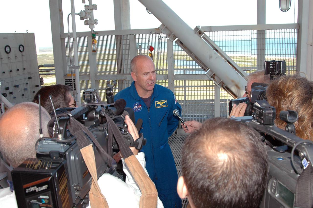 KENNEDY SPACE CENTER, FLA. -  Prior to a simulated launch countdown_emergency simulation on Launch Pad 39A, the media photograph and interview astronaut Alan G. Poindexter.  Pad team members participated in the four-hour exercise simulating normal launch countdown operations, with the added challenge of a fictitious event causing an evacuation of the vehicle and launch pad.  The simulation tested the team’s rescue approaches on the Fixed Service Structure, slidewire basket evacuation, triage care and transportation of injured personnel to hospitals, as well as communications and coordination.
