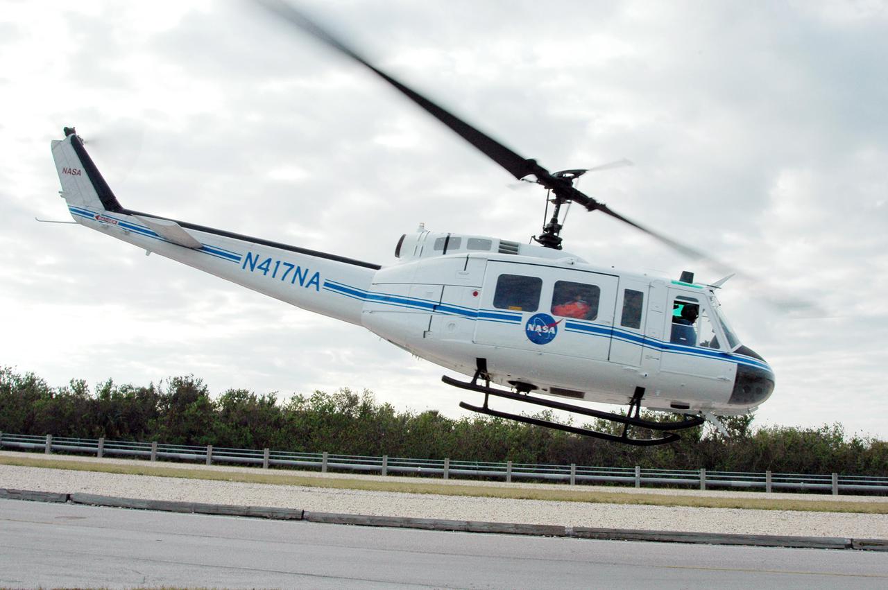 KENNEDY SPACE CENTER, FLA. -  During a simulated launch countdown_emergency simulation on Launch Pad 39A, the NASA helicopter leaves the scene with “injured” astronaut-suited workers, heading to a hospital.  Pad team members participated in the four-hour exercise simulating normal launch countdown operations, with the added challenge of a fictitious event causing an evacuation of the vehicle and launch pad.  The simulation tested the team’s rescue approaches on the Fixed Service Structure, slidewire basket evacuation, triage care and transportation of injured personnel to hospitals, as well as communications and coordination.
