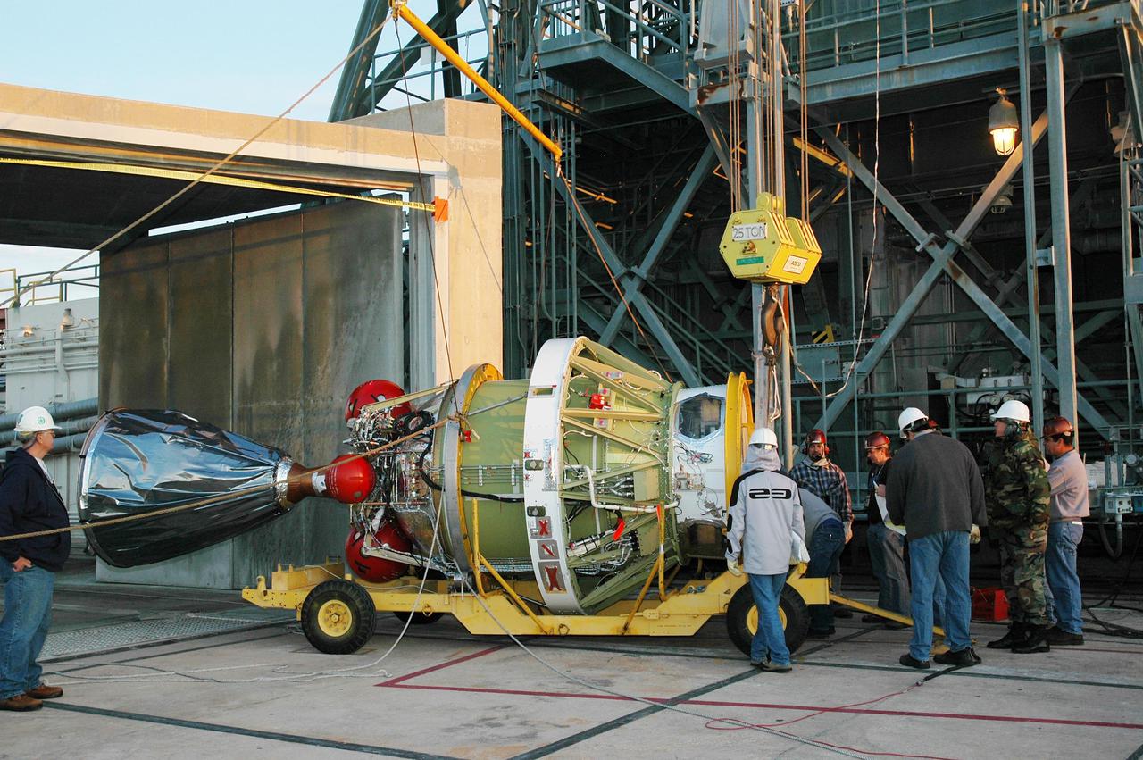 KENNEDY SPACE CENTER, FLA. -   On Launch Pad 17-B at Cape Canaveral Air Force Station, the second stage of the Boeing Delta II rocket arrives at the mobile service tower for mating to the rocket.  The Delta II will launch NASA’s Deep Impact spacecraft. A NASA Discovery mission, Deep Impact will probe beneath the surface of Comet Tempel 1 on July 4, 2005, when the comet is 83 million miles from Earth, and reveal the secrets of its interior.  After releasing an impactor on a course to hit the comet’s sunlit side, Deep Impact’s flyby spacecraft will collect pictures and data of how the crater forms, measure the crater’s depth and diameter, as well as the composition of the interior of the crater and any material thrown out, and determine the changes in natural outgassing produced by the impact.  It will send the data back to Earth through the antennas of the Deep Space Network.