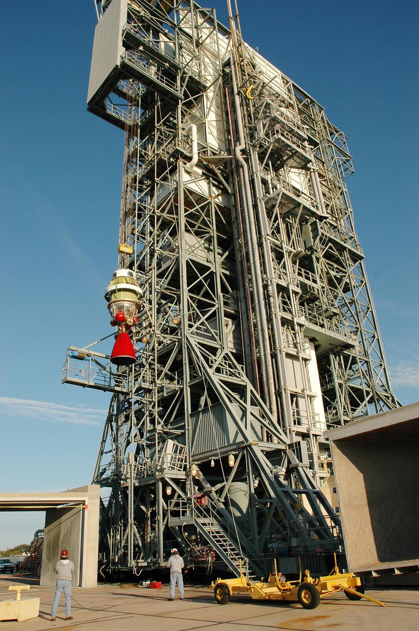 KENNEDY SPACE CENTER, FLA. - On Launch Pad 17-B at Cape Canaveral Air Force Station, the second stage of the Boeing Delta II rocket is lifted up the mobile service tower. The element will be mated to the Delta II, which will launch NASA’s Deep Impact spacecraft. A NASA Discovery mission, Deep Impact will probe beneath the surface of Comet Tempel 1 on July 4, 2005, when the comet is 83 million miles from Earth, and reveal the secrets of its interior. After releasing an impactor on a course to hit the comet’s sunlit side, Deep Impact’s flyby spacecraft will collect pictures and data of how the crater forms, measure the crater’s depth and diameter, as well as the composition of the interior of the crater and any material thrown out, and determine the changes in natural outgassing produced by the impact. It will send the data back to Earth through the antennas of the Deep Space Network.