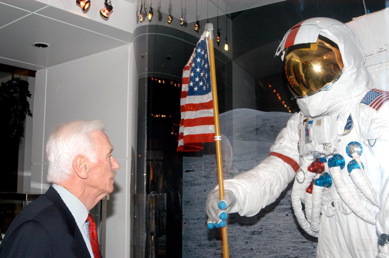 KENNEDY SPACE CENTER, FLA. -  Apollo 17 Commander Gene Cernan looks at the Moon landing display in the new Kennedy Space Center Store at Orlando International Airport. NASA’s Kennedy Space Center Director Jim Kennedy and Apollo 17 Commander Gene Cernan participated in the grand opening ceremony.  The store will help educate millions of airport visitors about America’s space program and the Vision for Space Exploration.  The store is operated by Kennedy Space Center Visitor Complex concessionaire Delaware North Parks and Resorts.