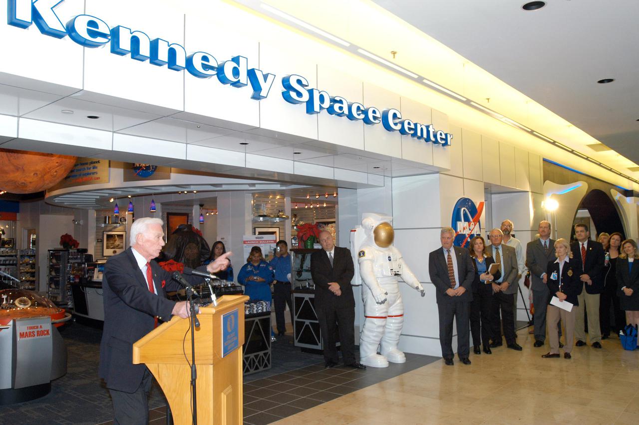 KENNEDY SPACE CENTER, FLA. -  Apollo 17 Commander Gene Cernan (left) holds the attention of guests at the grand opening ceremony of the new Kennedy Space Center Store at Orlando International Airport.  The store will help educate millions of airport visitors about America’s space program and the Vision for Space Exploration.  The store is operated by Kennedy Space Center Visitor Complex concessionaire Delaware North Parks and Resorts.