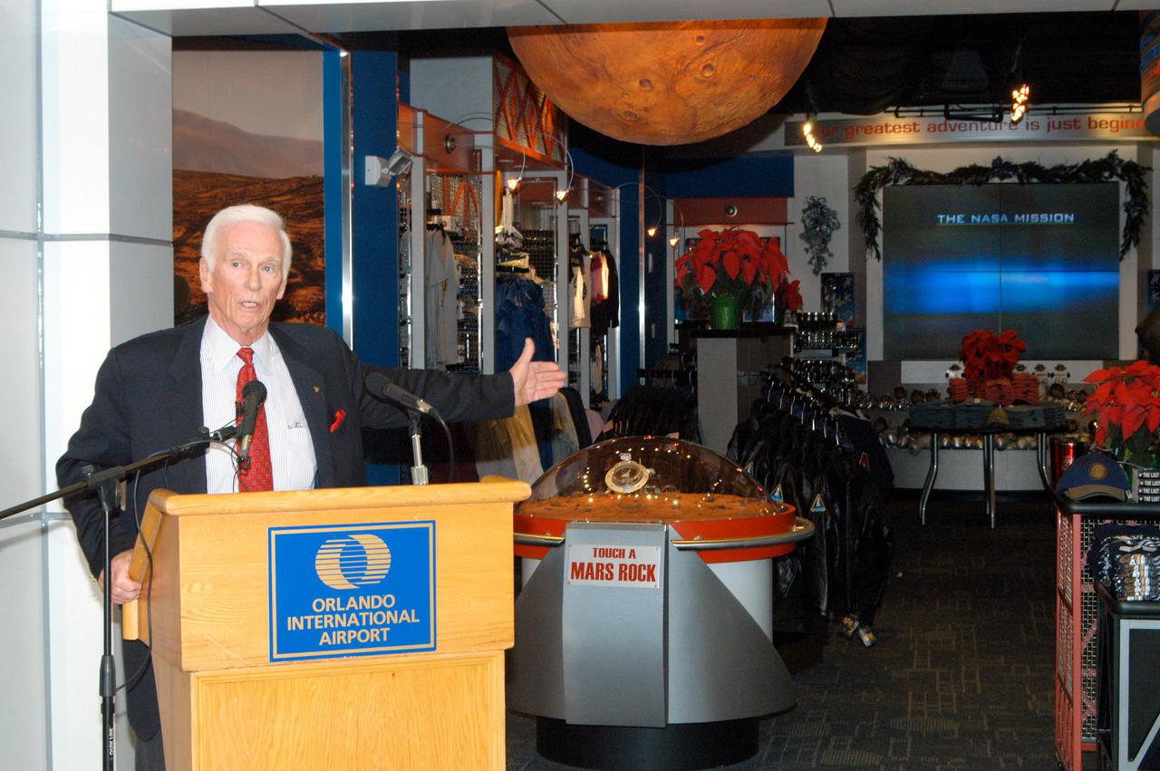 KENNEDY SPACE CENTER, FLA. -  Apollo 17 Commander Gene Cernan talks about some of the exhibits in the new Kennedy Space Center Store at Orlando International Airport.  NASA’s Kennedy Space Center Director Jim Kennedy and Cernan participated in the grand opening ceremony.  The store will help educate millions of airport visitors about America’s space program and the Vision for Space Exploration.  The store is operated by Kennedy Space Center Visitor Complex concessionaire Delaware North Parks and Resorts.