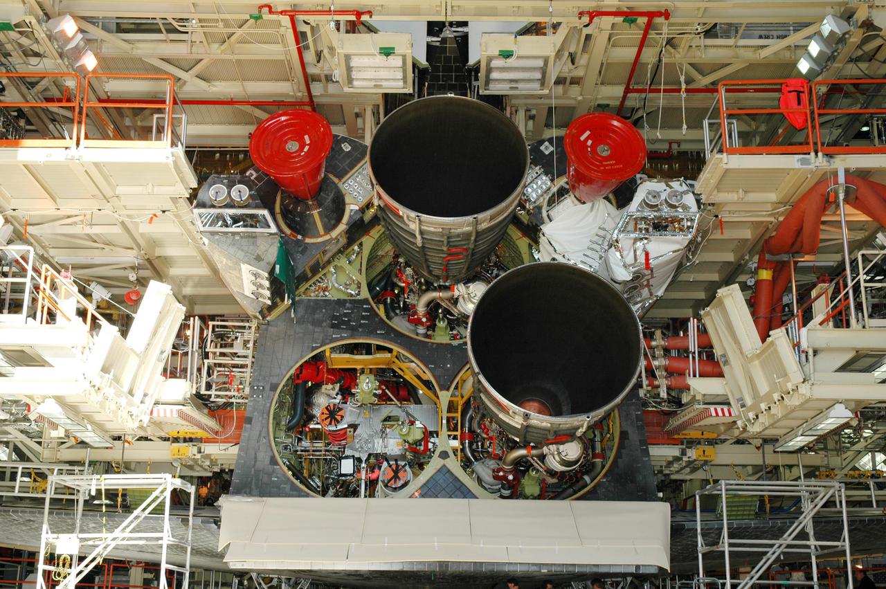 KENNEDY SPACE CENTER, FLA. -  The second Space Shuttle Main Engine (SSME) has been installed on the orbiter Discovery in the Orbiter Processing Facility.  Discovery is the vehicle designated for the Return to Flight mission STS-114. Overall, an SSME weighs approximately 7,000 pounds. An SSME operates at greater temperature extremes than any mechanical system in common use today. The liquid hydrogen fuel is -423 degrees Fahrenheit, the second coldest liquid on Earth. When the hydrogen is burned with liquid oxygen, the temperature in the engine's combustion chamber reaches +6000 degrees Fahrenheit -- that's higher than the boiling point of Iron.  Each SSME is controlled by its own computer, which checks the health of the engines 50 times per second during countdown and ascent. The controller can shut an engine down if it detects a problem. The SSMEs are tested at Stennis Space Center in Mississippi.