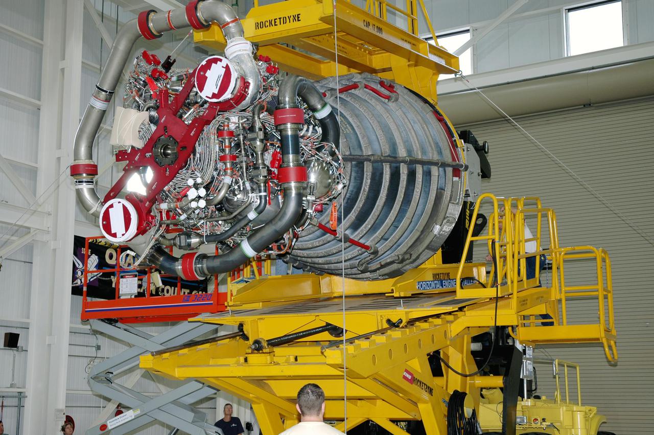 KENNEDY SPACE CENTER, FLA. - In the Space Shuttle Main Engine (SSME) Shop, the SSME is lowered onto the Hyster lift for transport to the Orbiter Processing Facility. There it will be installed in the orbiter Discovery for Return to Flight mission STS-114. This is the third SSME to be installed in Discovery. Overall, an SSME weighs approximately 7,000 pounds. An SSME operates at greater temperature extremes than any mechanical system in common use today. The liquid hydrogen fuel is -423 degrees Fahrenheit, the second coldest liquid on Earth. When the hydrogen is burned with liquid oxygen, the temperature in the engine's combustion chamber reaches +6000 degrees Fahrenheit -- higher than the boiling point of iron. Each SSME is controlled by its own computer, which checks the health of the engines 50 times per second during countdown and ascent. The controller can shut an engine down if it detects a problem.