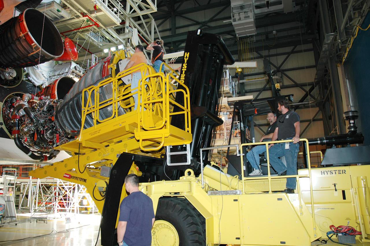 KENNEDY SPACE CENTER, FLA. - In the Orbiter Processing Facility, the Hyster lift raises the third Space Shuttle Main Engine (SSME) into position behind Discovery for installation. Discovery is designated as the Return to Flight vehicle for mission STS-114. Recent improvements to the SSME include the introduction of redesigned high-pressure turbopumps into the SSME fleet. The new pumps are designed and built by Pratt and Whitney at West Palm Beach, Fla. SSMEs and the Pratt and Whitney turbopumps are tested at Stennis Space Center in Mississippi. Engines and engine components are delivered to Kennedy Space Center to be prepared for flight.