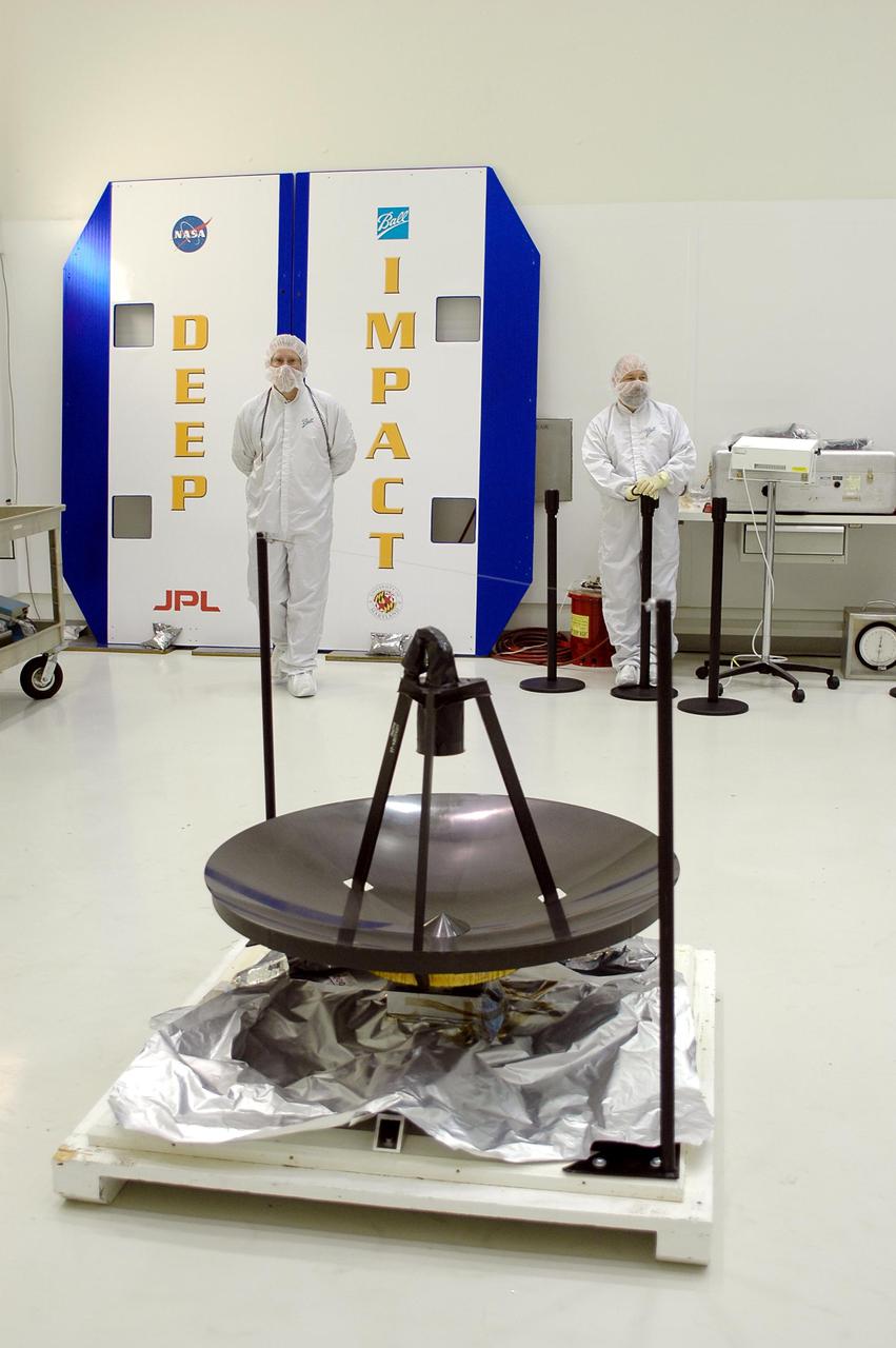 KENNEDY SPACE CENTER, FLA. -  At Astrotech in Titusville, Fla., the high-gain communications antenna is ready for installation on the Deep Impact spacecraft (behind it). A NASA Discovery mission, Deep Impact will probe beneath the surface of Comet Tempel 1 on July 4, 2005, when the comet is 83 million miles from Earth, and reveal the secrets of its interior.   During the encounter phase, the high-gain antenna transmits near-real-time images of the impact back to Earth. The spacecraft is scheduled to launch Jan. 8 aboard a Boeing Delta II rocket from Launch Complex 17-B at Cape Canaveral Air Force Station, Fla.