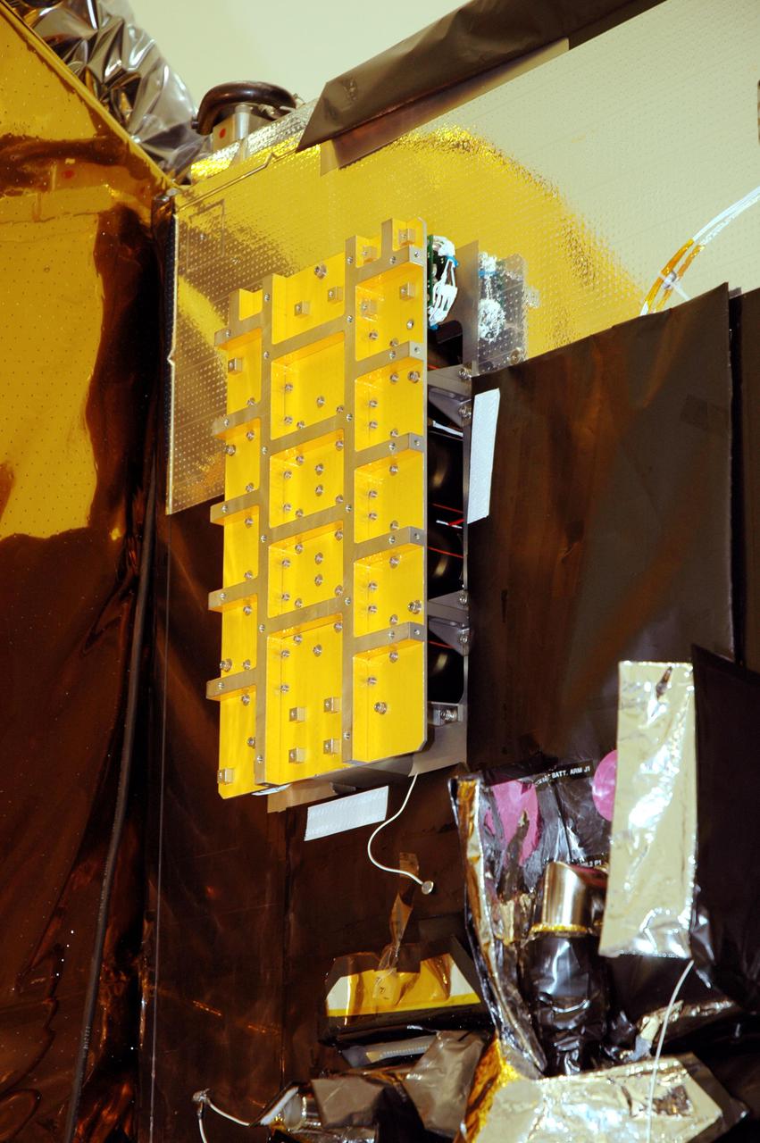 KENNEDY SPACE CENTER, FLA. - At Astrotech Space Operations in Titusville, Fla., the flight battery has been installed on the Deep Impact flyby spacecraft. About the size of a Ford Explorer, the flyby spacecraft is three-axis stabilized and uses a fixed solar array and a small NiH2 battery for its power system. A NASA Discovery mission, Deep Impact will probe beneath the surface of Comet Tempel 1 on July 4, 2005, when the comet is 83 million miles from Earth. During the encounter phase when the comet collides with the impactor projectile propelled into its path, the spacecraft’s high-gain antenna will transmit near-real-time images of the impact back to Earth. The spacecraft is scheduled to launch Jan. 8 aboard a Boeing Delta II rocket from Launch Complex 17-B at Cape Canaveral Air Force Station, Fla.