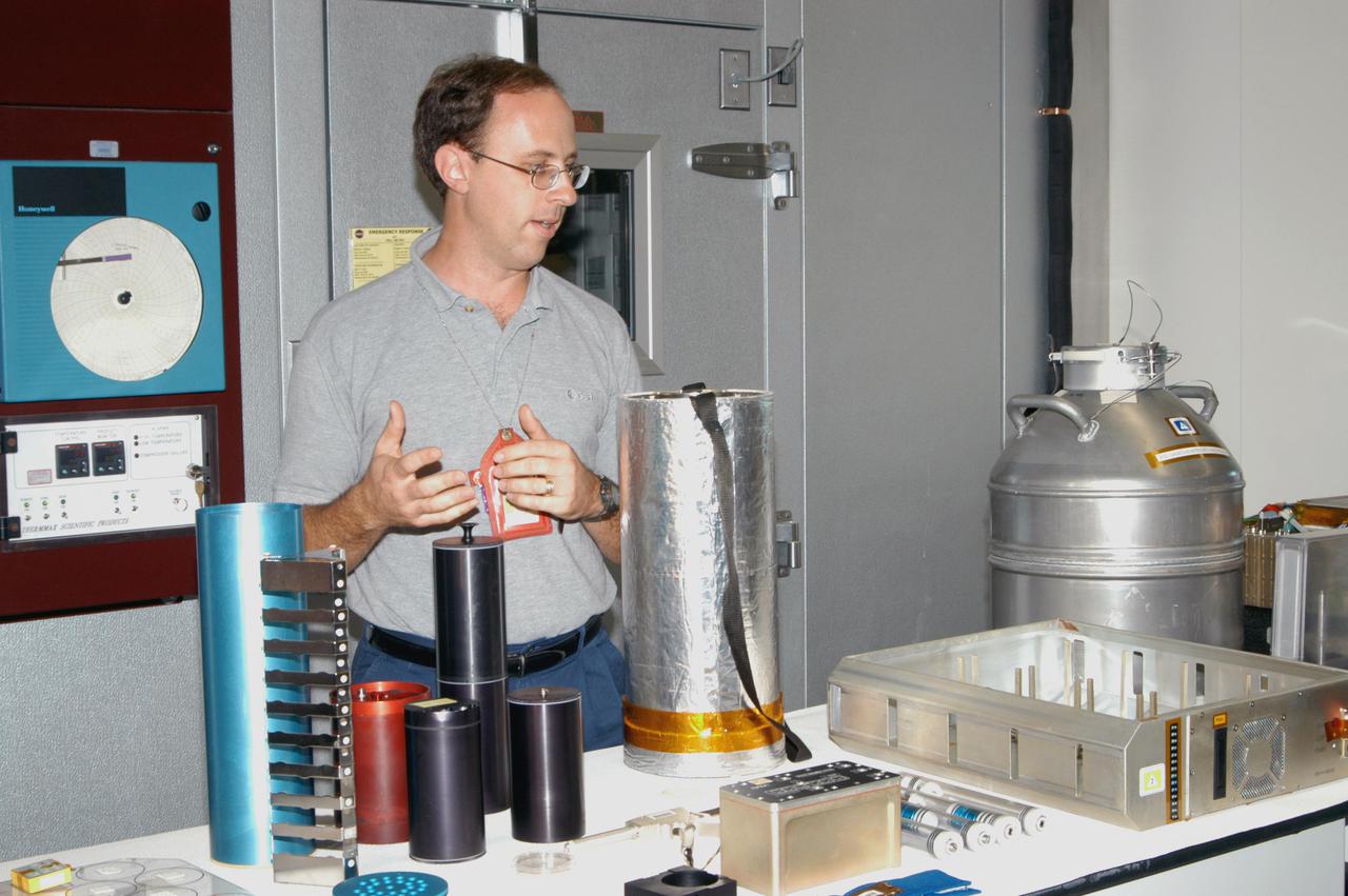 KENNEDY SPACE CENTER, FLA. - Dave Reed, a project engineer with the Bionetics Corporation, discusses the various flight hardware developed or currently being developed for future space exploration missions during a tour of the Space Life Sciences Lab for members of the news media. The Exploration Flight Development and Demonstration project provides innovative and cost effective hardware solutions focused on advancing critical technologies while reducing equivalent system mass as well as safe, thorough and efficient flight vehicle platform integration of Human System Research and Technology experiments that fly on parabolic aircraft, the Space Shuttle, and International Space Station.