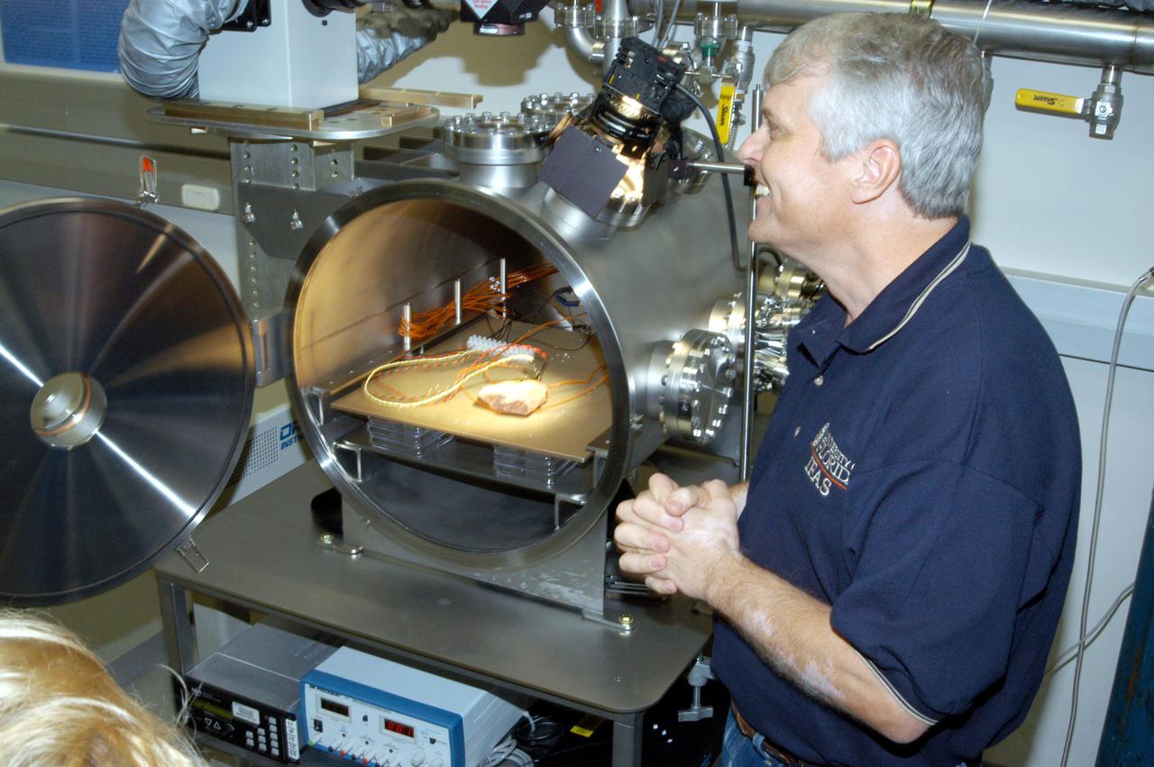 KENNEDY SPACE CENTER, FLA. - Andy Schuerger, a research assistant professor with the University of Florida, demonstrates the Mars Simulation Chamber at the Space Life Sciences Lab during a tour of the facility for members of the news media. Schuerger is studying the effects of interplanetary space and Mars surface conditions on the survival, growth, and potential adaption of terrestrial microbes to the martian surface.