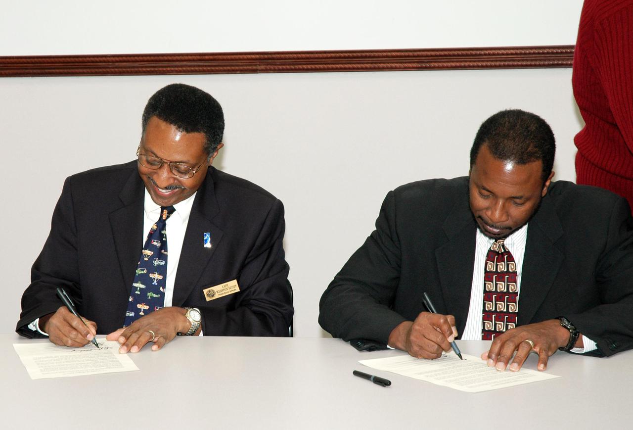 KENNEDY SPACE CENTER, FLA. -  Leaders of prominent Florida space organizations convened at the Florida Space Authority campus in Cape Canaveral to sign a memorandum of agreement with the Space Foundation to launch the first “Florida Space” conference. Retired Navy Capt. Winston E. Scott (left), executive director of the Florida Space Authority, and Dr. Woodrow Whitlow Jr., deputy director of the Kennedy Space Center, sign copies of the agreement for their respective organizations. Others present to sign the agreement are Dr. James W. Johnson, chairman of the Canaveral Council of Technical Societies; Col. Mark H. Owen, commander of the 45th Space Wing at Patrick Air Force Base; and Elliot G. Pulham, president and chief executive officer of the Space Foundation. The conference will combine and build on the best features of previous Florida space events including Space Congress and the Cape Canaveral Spaceport Symposium. Both will be retired now in favor of this new event to be held annually and operated by the Space Foundation. Florida Space 2005 will be presented in November 2005.