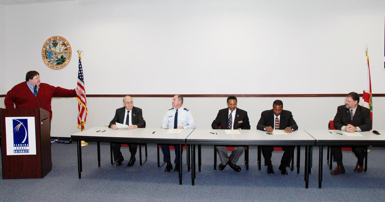 KENNEDY SPACE CENTER, FLA. -  Leaders of prominent Florida space organizations convened at the Florida Space Authority campus in Cape Canaveral to sign a memorandum of agreement with the Space Foundation to launch the first “Florida Space” conference. From left are Jim Banke (at podium), vice president of Florida operations for the Space Foundation; Dr. James W. Johnson, chairman of the Canaveral Council of Technical Societies; Col. Mark H. Owen, commander of the 45th Space Wing at Patrick Air Force Base; retired Navy Capt. Winston E. Scott, executive director of the Florida Space Authority; Dr. Woodrow Whitlow Jr., deputy director of the Kennedy Space Center; and Elliot G. Pulham, president and chief executive officer of the Space Foundation. The conference will combine and build on the best features of previous Florida space events including Space Congress and the Cape Canaveral Spaceport Symposium. Both will be retired now in favor of this new event to be held annually and operated by the Space Foundation. Florida Space 2005 will be presented in November 2005.