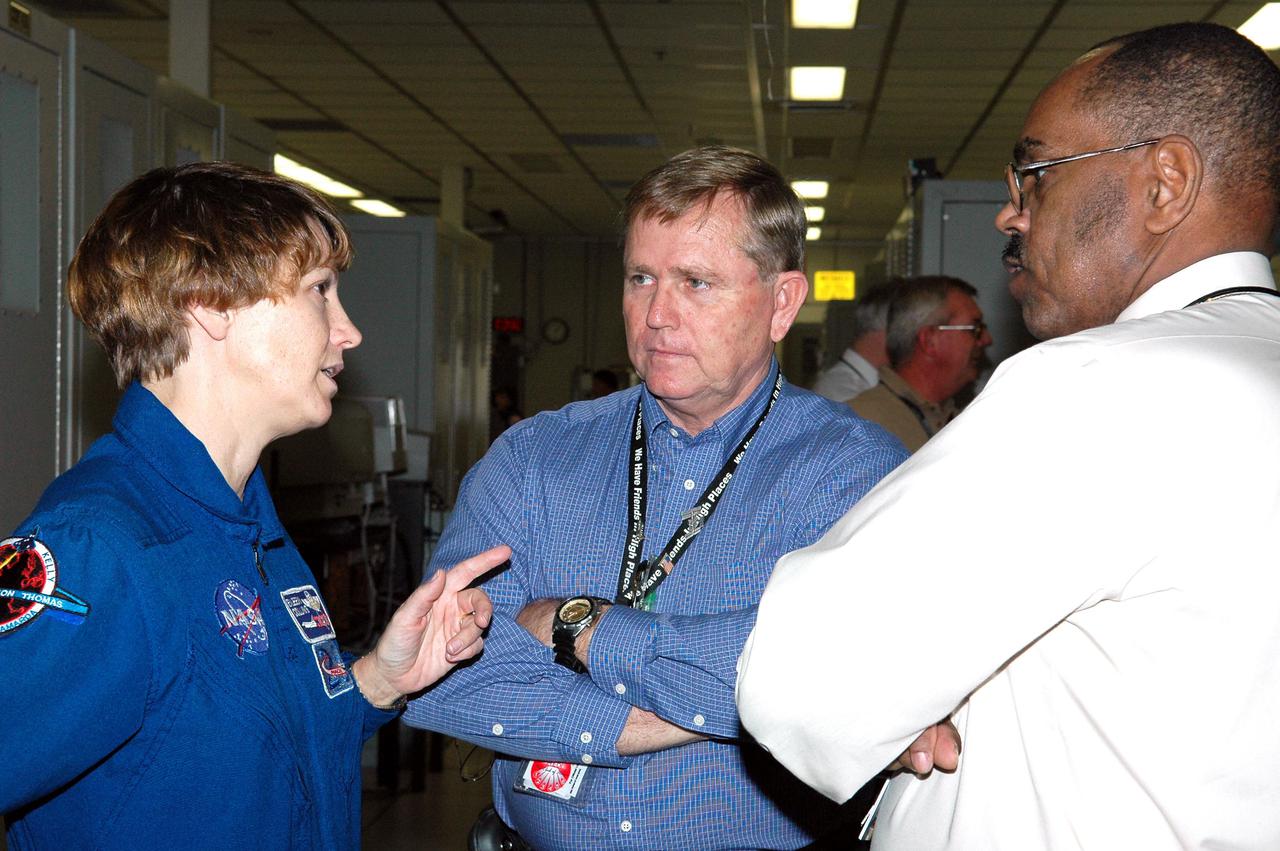 KENNEDY SPACE CENTER, FLA. -  While visiting Kennedy Space Center, STS-114  Commander Eileen Collins (left) talks with  John Bailey, MILA Support Services manager, and Harold Stinger, SGT president, in the MILA  Spaceflight Tracking and Data Network Station. The tracking station serves as the primary voice, data and telemetry communications link between the Shuttle and the ground from launch until 7-1_2 minutes into the flight. Millions of clues about the performance of the Space Shuttle’s main engines and other components are communicated to launch managers, technicians and engineers on the ground, who must keep their fingers on the pulse of the Space Shuttle during the critical ascent period. In a typical year, MILA provides through KSC more than 10,000 hours of data between spacecraft and data users.  MILA is also used during a Space Shuttle landing at KSC and provides communications beginning about 13 minutes before touchdown. Also, MILA can be called upon to provide data transfer support for NASA’s Expendable Launch Vehicle missions and orbiting scientific satellites.