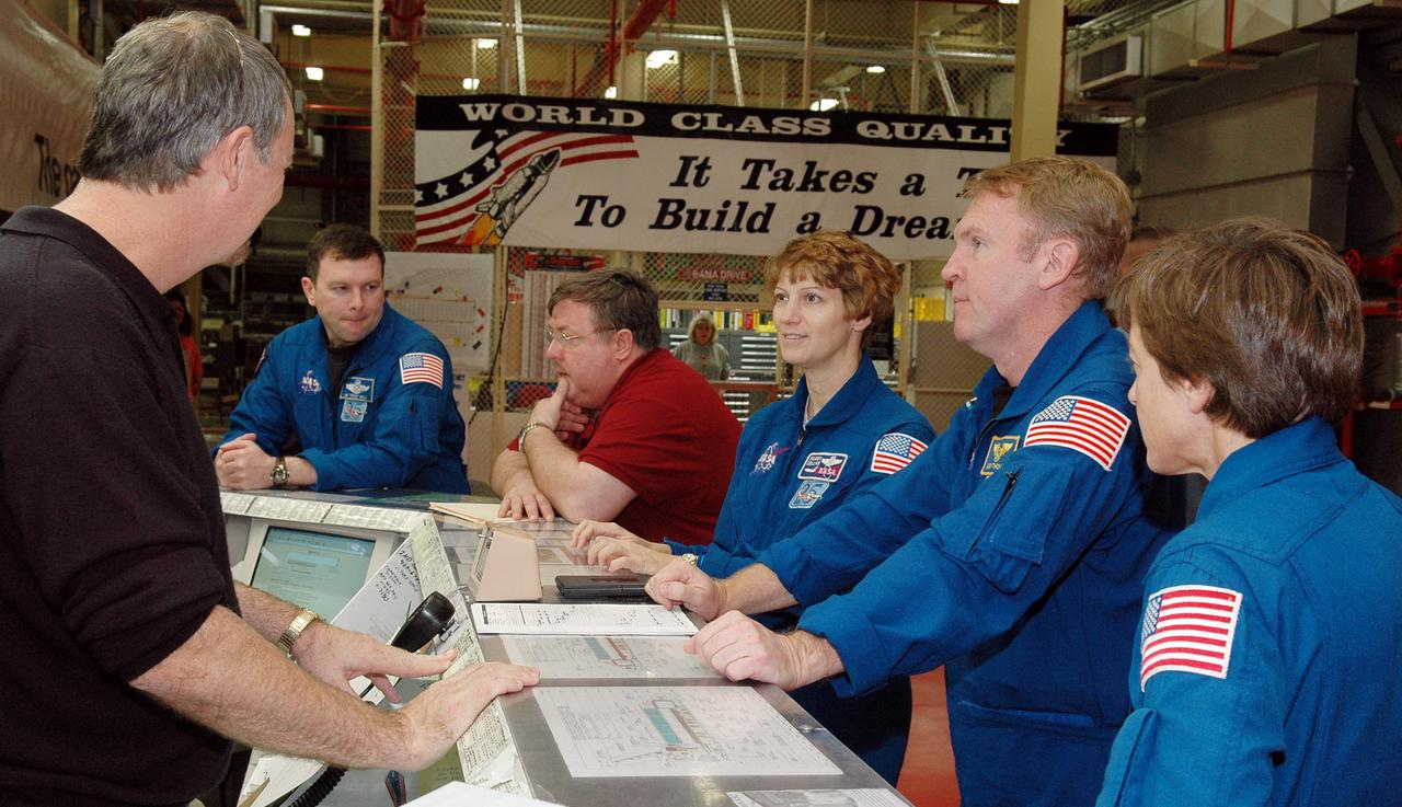 KENNEDY SPACE CENTER, FLA. -  On a visit to Kennedy, members of the STS-114 crew stop by the Orbiter Processing Facility.  Seen here are Pilot James Kelly (second from left), Commander Eileen Collins, and Mission Specialists Andrew Thomas and Wendy Lawrence.  The designated orbiter vehicle for the mission, Discovery, is in the OPF for launch processing. Discovery is scheduled for a launch planning window of May 12 to June 3, 2005.