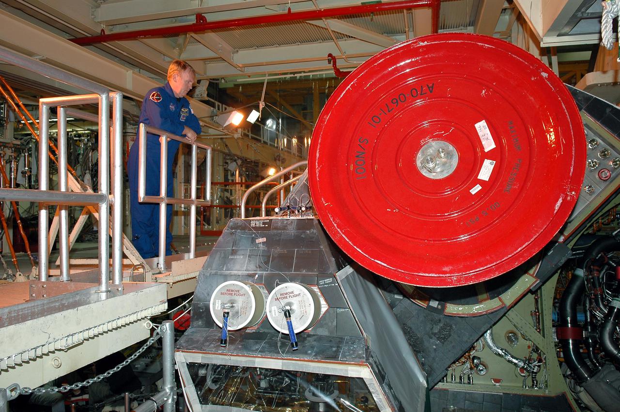 KENNEDY SPACE CENTER, FLA. -  On a visit to Kennedy, STS-114 Mission Specialist Andrew Thomas views closely one of the main engines recently installed on Discovery, the designated vehicle for the mission.  Discovery is in the Orbiter Processing Facility for launch processing. Discovery is scheduled for a launch planning window of May 12 to June 3, 2005.
