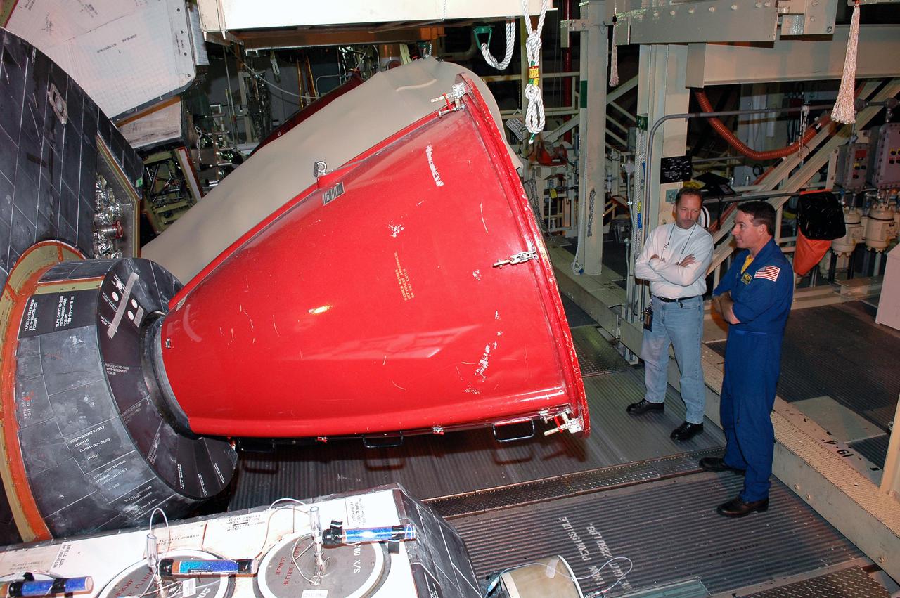 KENNEDY SPACE CENTER, FLA. -  On a visit to Kennedy, STS-114 Mission Specialist Stephen Robinson takes a close look at one of the main engines recently installed on Discovery, the designated vehicle for the mission.  Discovery is in the Orbiter Processing Facility for launch processing. Discovery is scheduled for a launch planning window of May 12 to June 3, 2005.