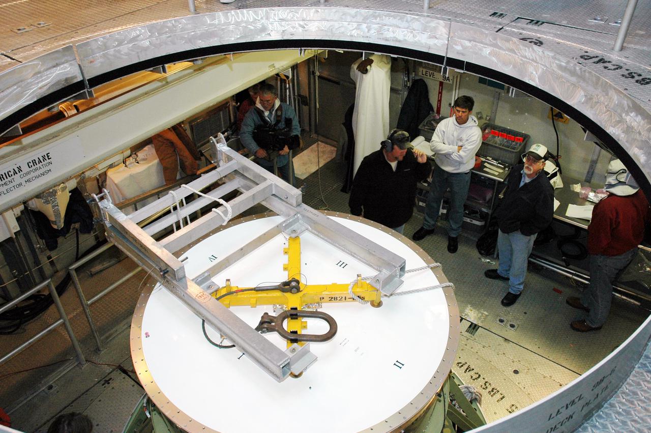 KENNEDY SPACE CENTER, FLA. - In the mobile service tower on Pad 17-B, Cape Canaveral Air Force Station, Fla., Boeing technicians prepare to remove the second stage from the Boeing Delta II rocket that will launch the Deep Impact spacecraft. Removal of the second stage will allow workers to then remove the rocket’s inter-stage adapter, which was found to be faulty during a review of launch vehicle hardware. It will be replaced and the second stage re-installed within a few days. Launch of Deep Impact is now scheduled no earlier than Jan. 12.