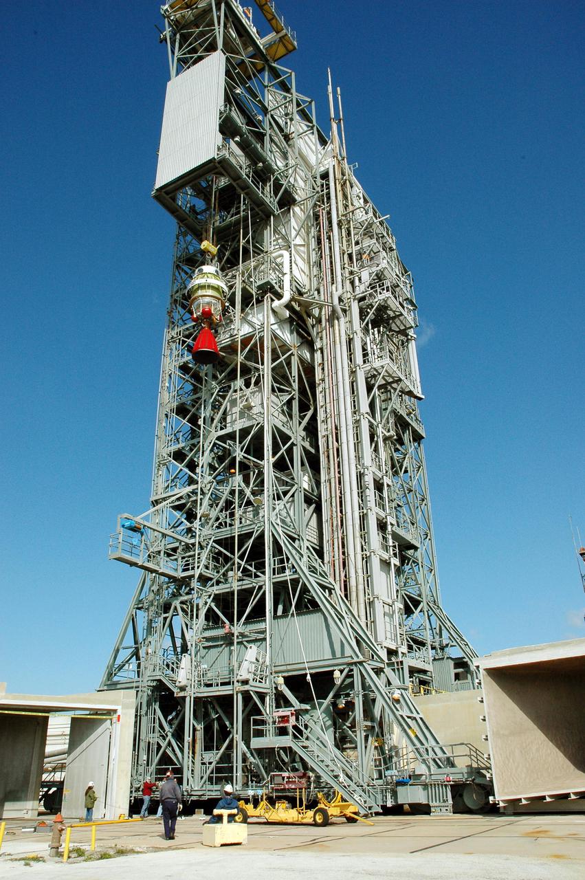 KENNEDY SPACE CENTER, FLA. -  On Pad 17-B, Cape Canaveral Air Force Station, Fla., the second stage of the Boeing Delta II rocket can be seen being lowered to the ground.  Removal of the second stage will allow workers to then remove the rocket’s inter-stage adapter, which was found to be faulty during a review of launch vehicle hardware.  It will be replaced and the second stage re-installed within a few days.  Launch of Deep Impact is now scheduled no earlier than Jan. 12.