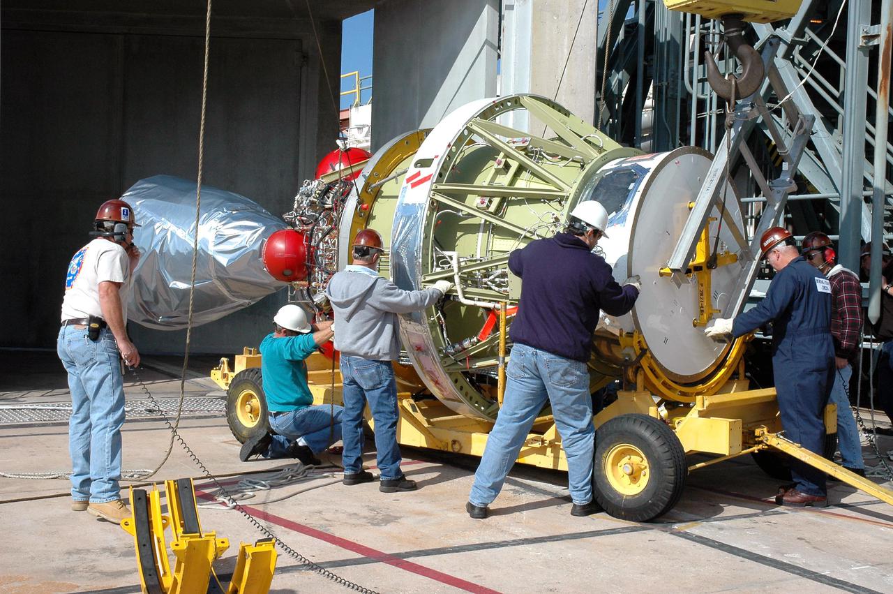 KENNEDY SPACE CENTER, FLA. -  After removal from the Boeing Delta II rocket and off the mobile service tower on Pad 17-B, Cape Canaveral Air Force Station, Fla., the second stage is lowered onto a transporter.  The second stage will be stored temporarily until the inter-stage adapter on the rocket can be replaced.  Removal of the second stage will allow workers to then remove the rocket’s inter-stage adapter, which was found to be faulty during a review of launch vehicle hardware.  It will be replaced and the second stage re-installed within a few days.  Launch of Deep Impact is now scheduled no earlier than Jan. 12.