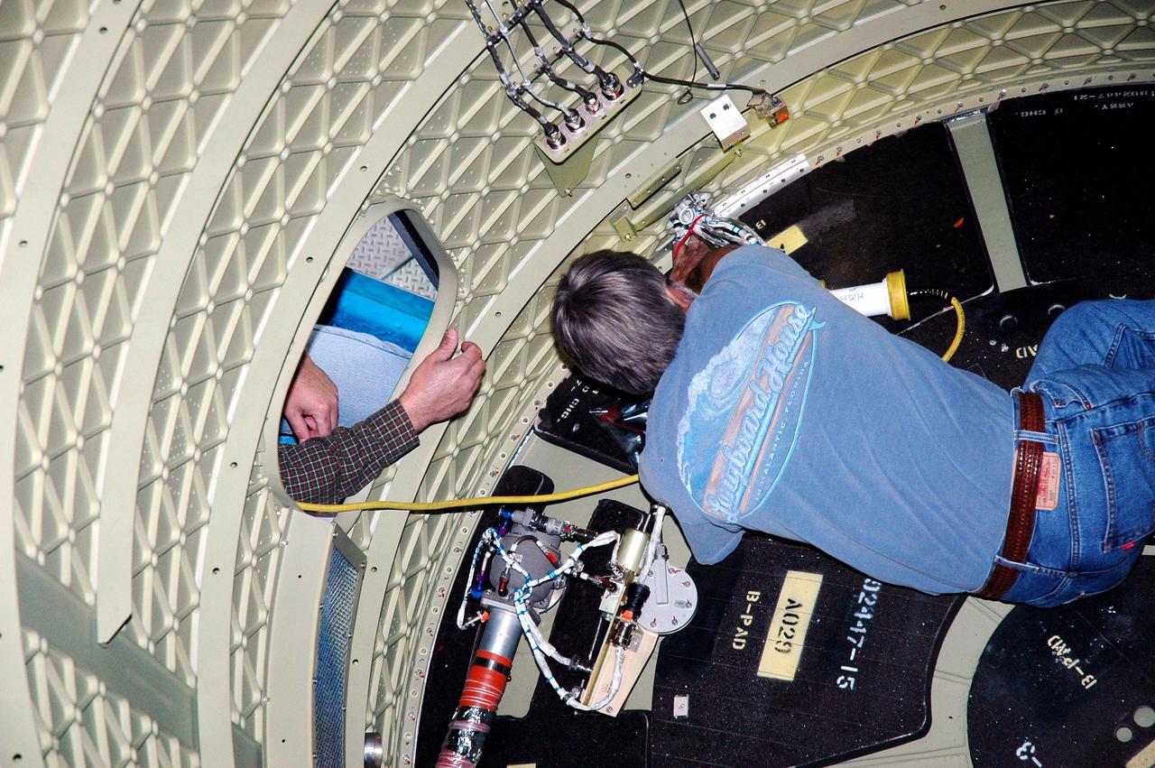 KENNEDY SPACE CENTER, FLA. -  In the mobile service tower on Pad 17-B, Cape Canaveral Air Force Station , Fla., a technician works inside the Boeing Delta II interstage adapter, which is being removed. The interstage adapter was found to be faulty during a review of launch vehicle hardware.  It will be replaced, and the second stage previously removed will be re-installed within a few days.  Launch of Deep Impact is now scheduled no earlier than Jan. 12.