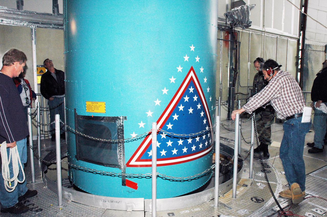 KENNEDY SPACE CENTER, FLA. -  In the mobile service tower on Pad 17-B, Cape Canaveral Air Force Station , Fla., the Boeing Delta II interstage adapter is being lowered out of the tower. The interstage adapter was found to be faulty during a review of launch vehicle hardware.  It will be replaced, and the second stage previously removed will be re-installed within a few days.  Launch of Deep Impact is now scheduled no earlier than Jan. 12.