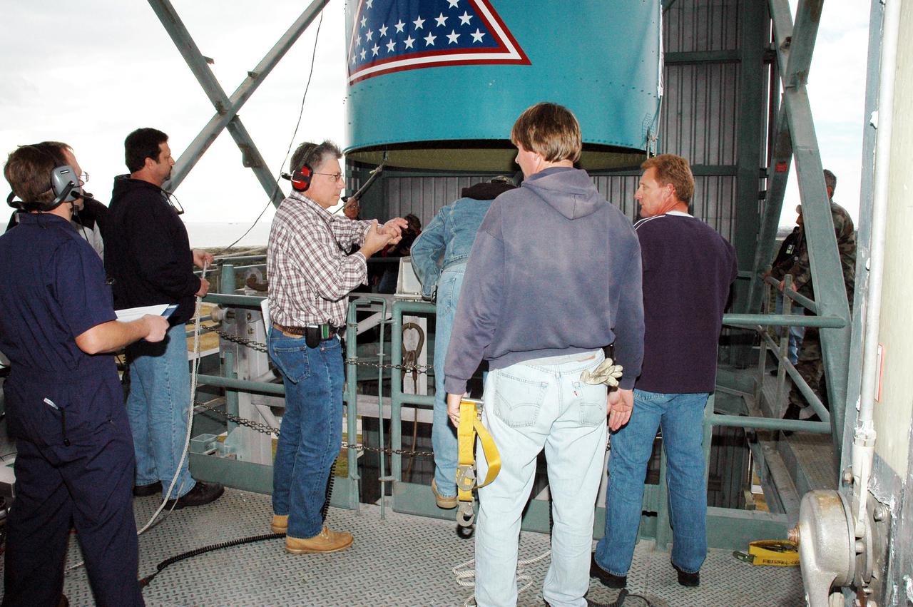 KENNEDY SPACE CENTER, FLA. -  In the mobile service tower on Pad 17-B, Cape Canaveral Air Force Station , Fla., the Boeing Delta II interstage adapter is being lowered out of the tower. The interstage adapter was found to be faulty during a review of launch vehicle hardware.  It will be replaced, and the second stage previously removed will be re-installed within a few days.  Launch of Deep Impact is now scheduled no earlier than Jan. 12.