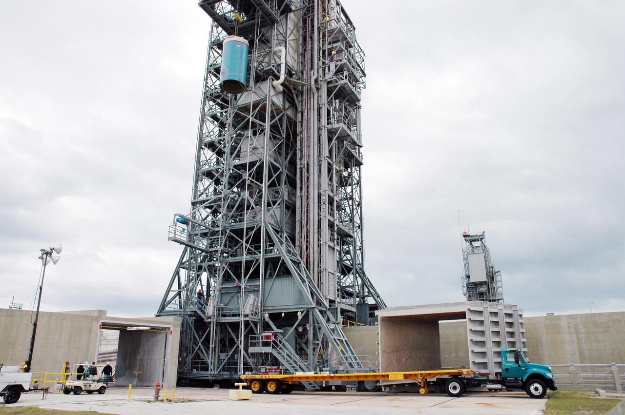 KENNEDY SPACE CENTER, FLA. -  On Pad 17-B, Cape Canaveral Air Force Station , Fla., Boeing Delta II interstage adapter is seen being lowered toward the pad. The interstage adapter was found to be faulty during a review of launch vehicle hardware.  It will be replaced, and the second stage previously removed will be re-installed within a few days.  Launch of Deep Impact is now scheduled no earlier than Jan. 12.