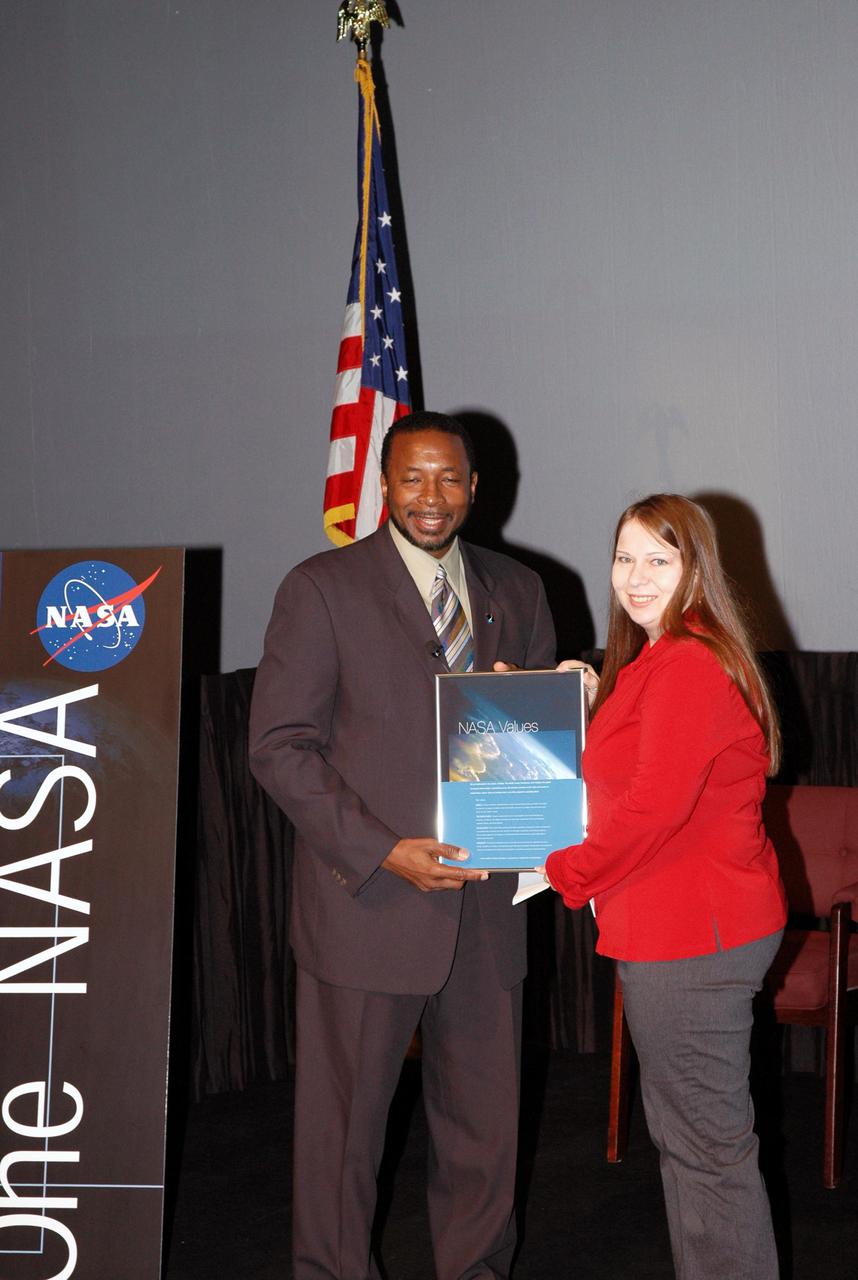 KENNEDY SPACE CENTER, FLA. -  Kennedy’s Deputy Director Woodrow Whitlow Jr. presents Pattie Lewis an award for a winning entry in the NASA Values essay contest.  The award was presented during the One NASA Leader-Led Workshop, which presented senior leadership in the Agency talking about ongoing Transformation activities and Kennedy’s role in the Vision for Space Exploration.