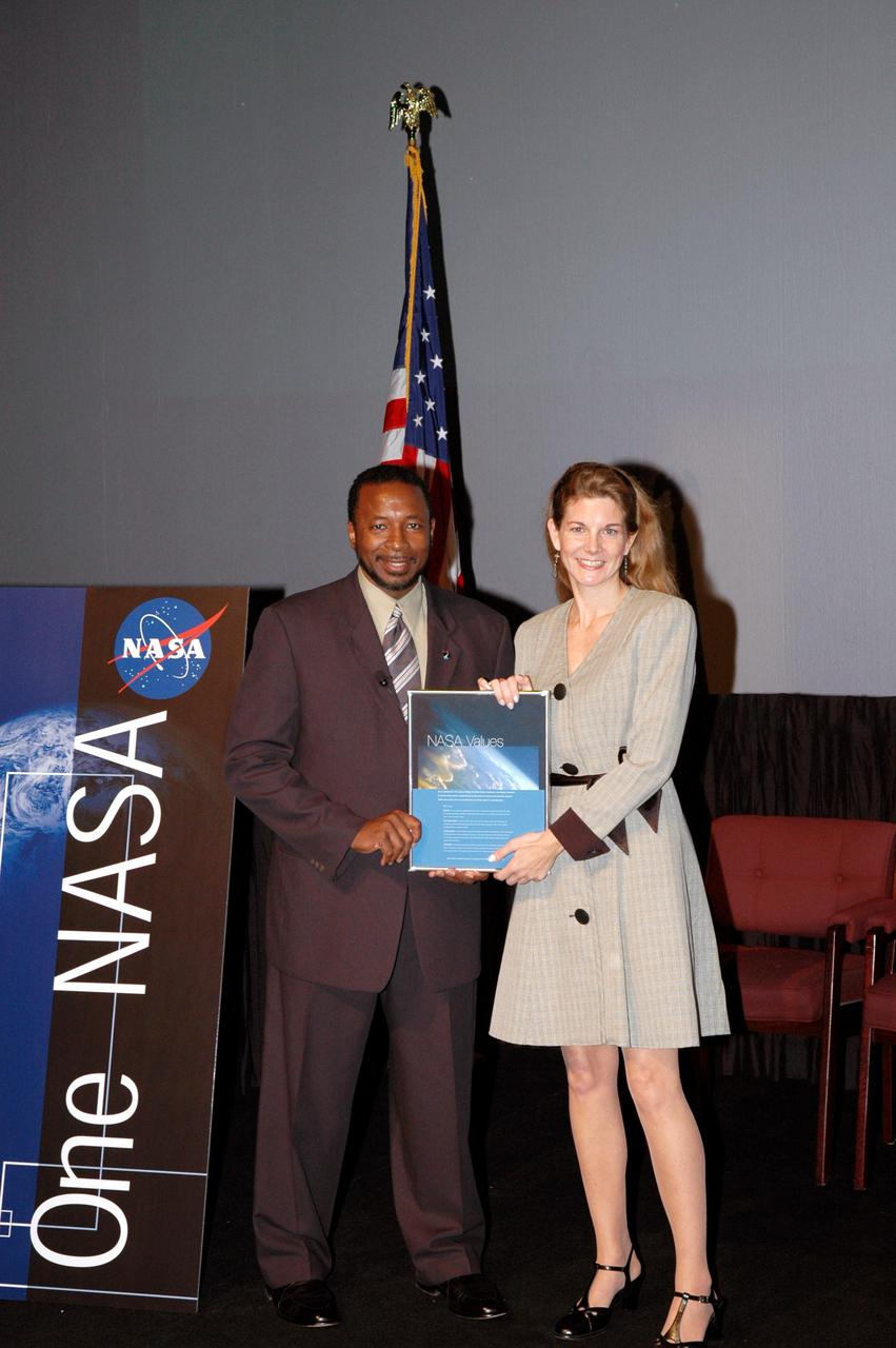 KENNEDY SPACE CENTER, FLA. -  Kennedy’s Deputy Director Woodrow Whitlow Jr. presents Mary Erdmann an award for a winning entry in the NASA Values essay contest. The award was presented during the One NASA Leader-Led Workshop, which presented senior leadership in the Agency talking about ongoing Transformation activities and Kennedy’s role in the Vision for Space Exploration.