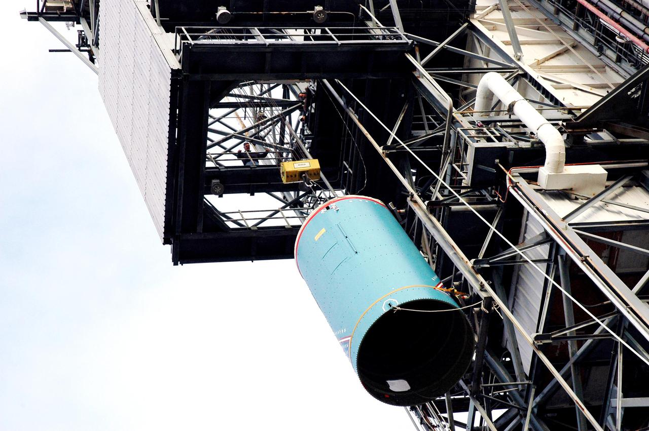 KENNEDY SPACE CENTER, FLA. -  The replacement interstage adapter for the Boeing Delta II launch vehicle for the Deep Impact spacecraft is lifted up the mobile service tower on Launch Pad 17-B, Cape Canaveral Air Force Station, Fla.   Boeing workers will attach the adapter to the rocket’s center body section.  Later the second stage, which was removed to allow access to the previous adapter, will be reattached. The first adapter was removed after it was found to be faulty during a review of launch vehicle hardware. Launch of Deep Impact is now scheduled no earlier than Jan. 12.